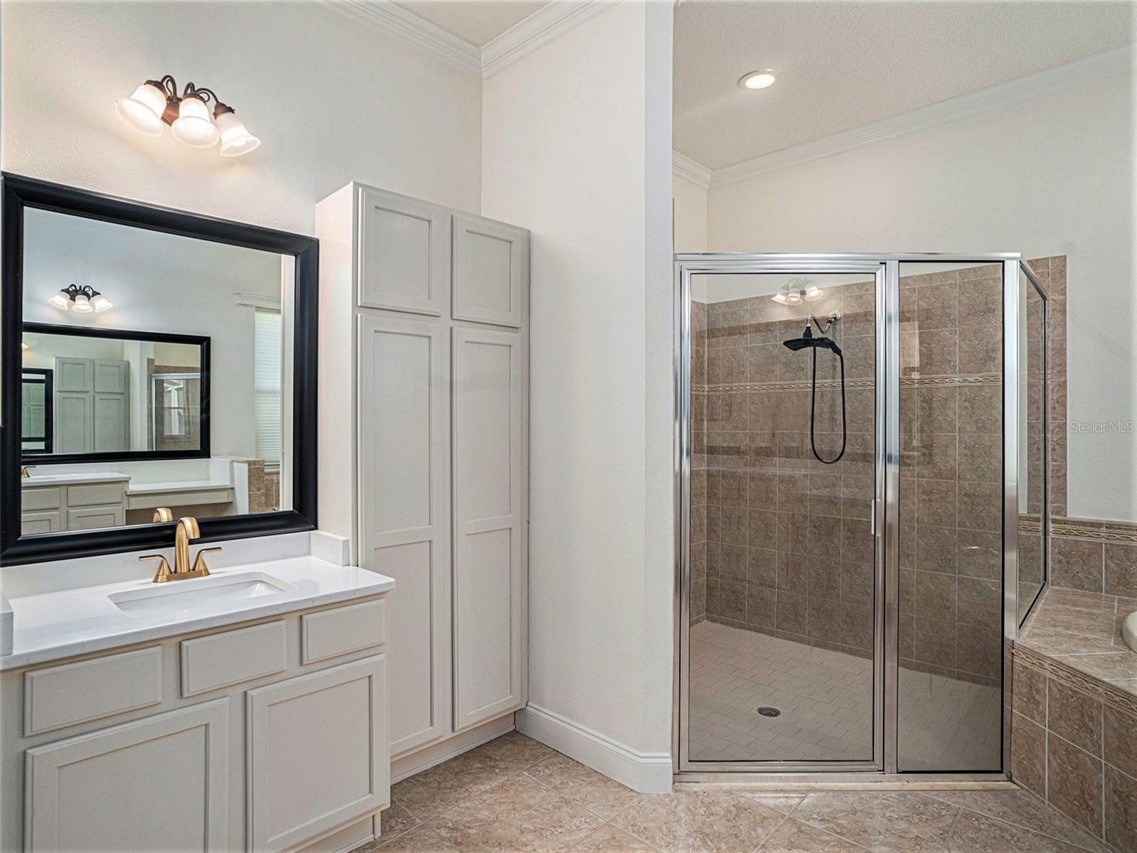 Master Bathroom with split vanities and storage unit