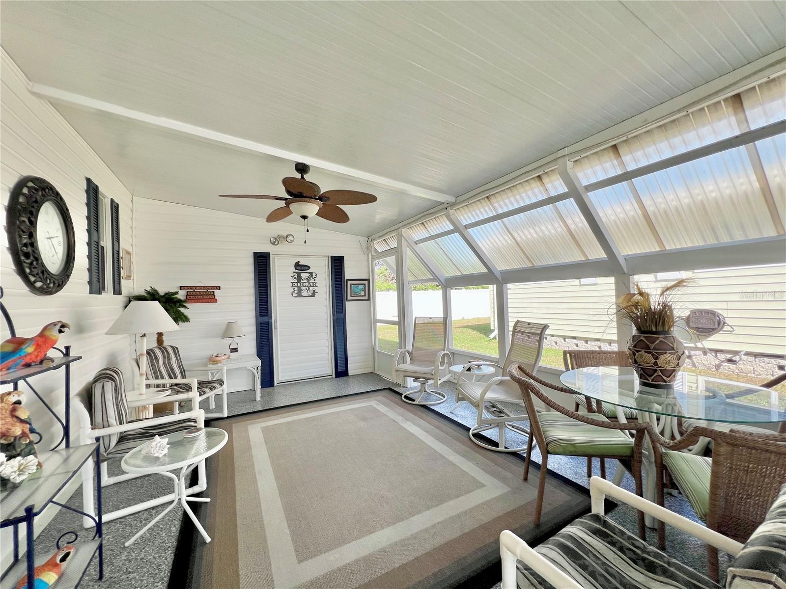 Enclosed screen patio under carport