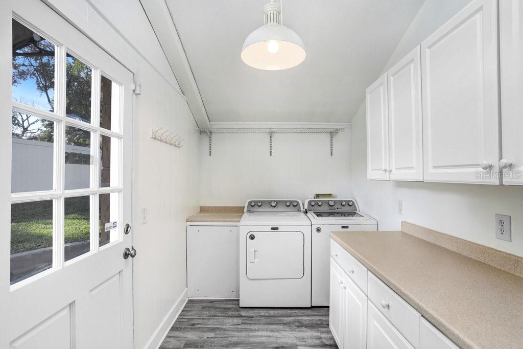 Large laundry room with shelving and countertops