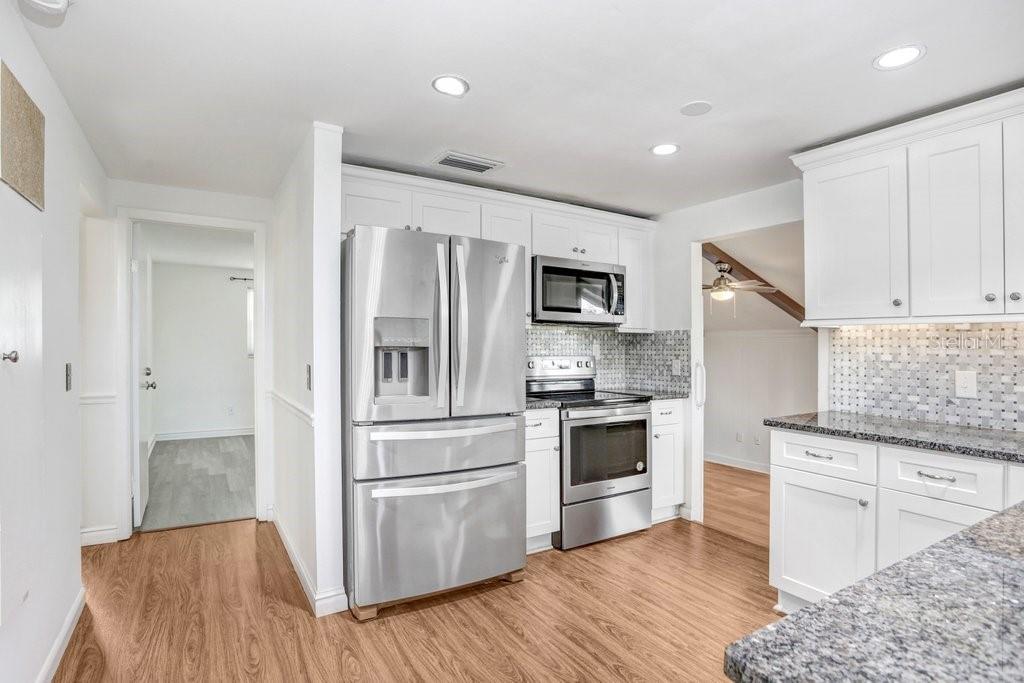 Kitchen with new back splash, granite, cabinets and stainless steel appliances