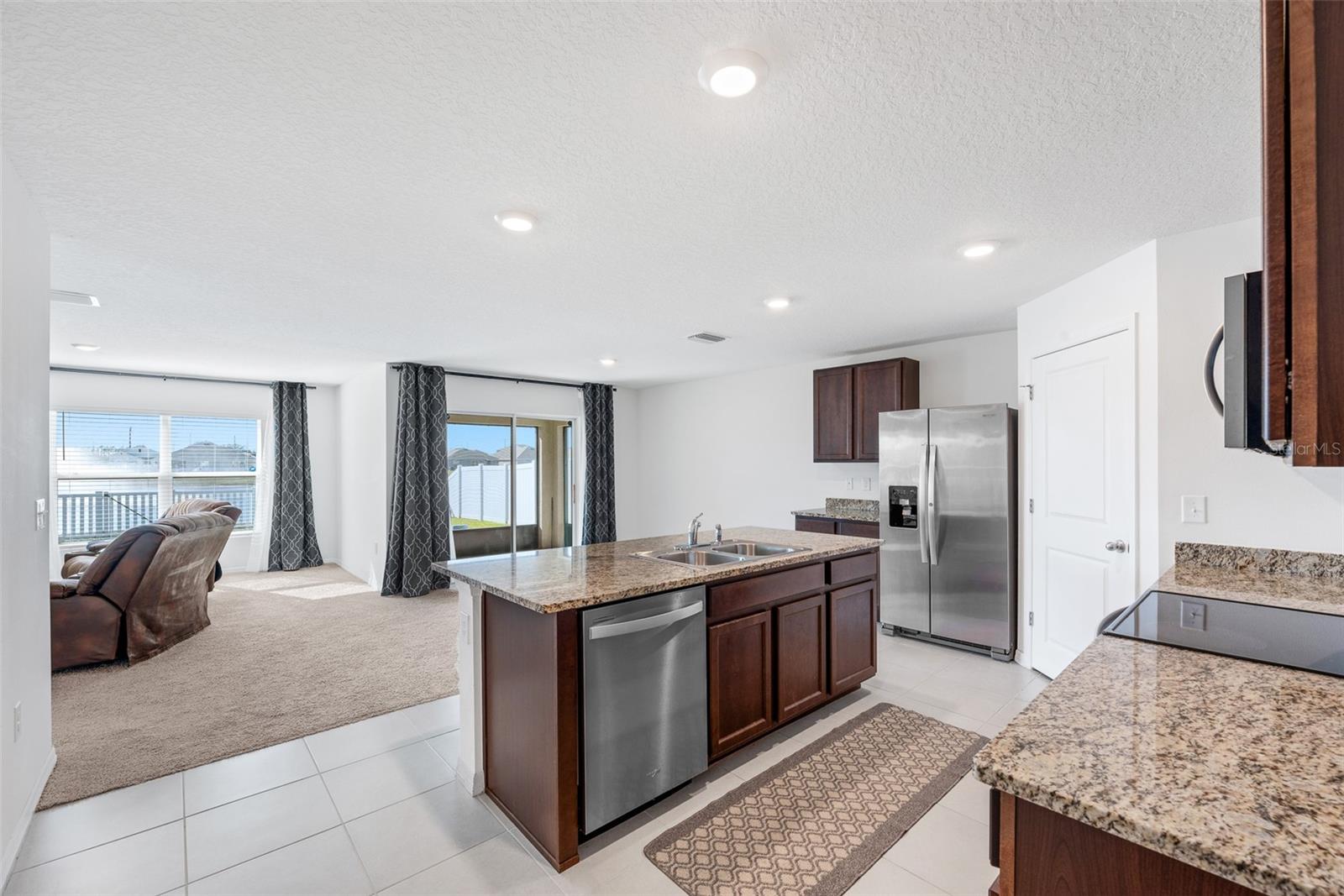 The spacious kitchen flows seamlessly into a welcoming family area