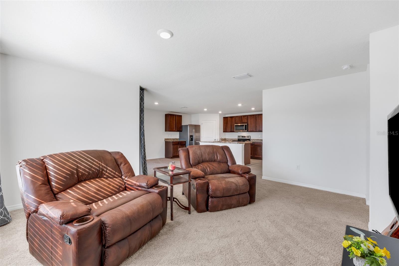 The living area is filled with natural light and has views of the water feature in the back of the home.