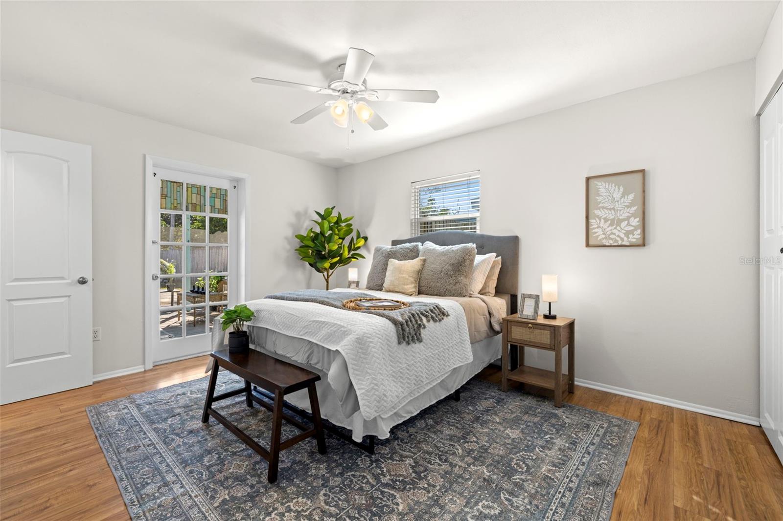 Primary Bedroom with en-suite, with door to screened in patio & pool