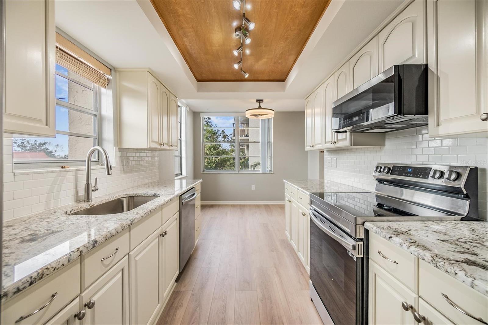 Remodeled galley-style kitchen with beautiful granite countertops, new stainless steel appliances, plenty of cabinet space, pantry, and a breakfast nook.