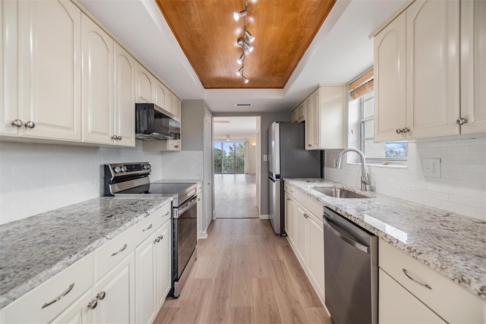 Remodeled galley-style kitchen with beautiful granite countertops, new stainless steel appliances, plenty of cabinet space, pantry, and a breakfast nook.