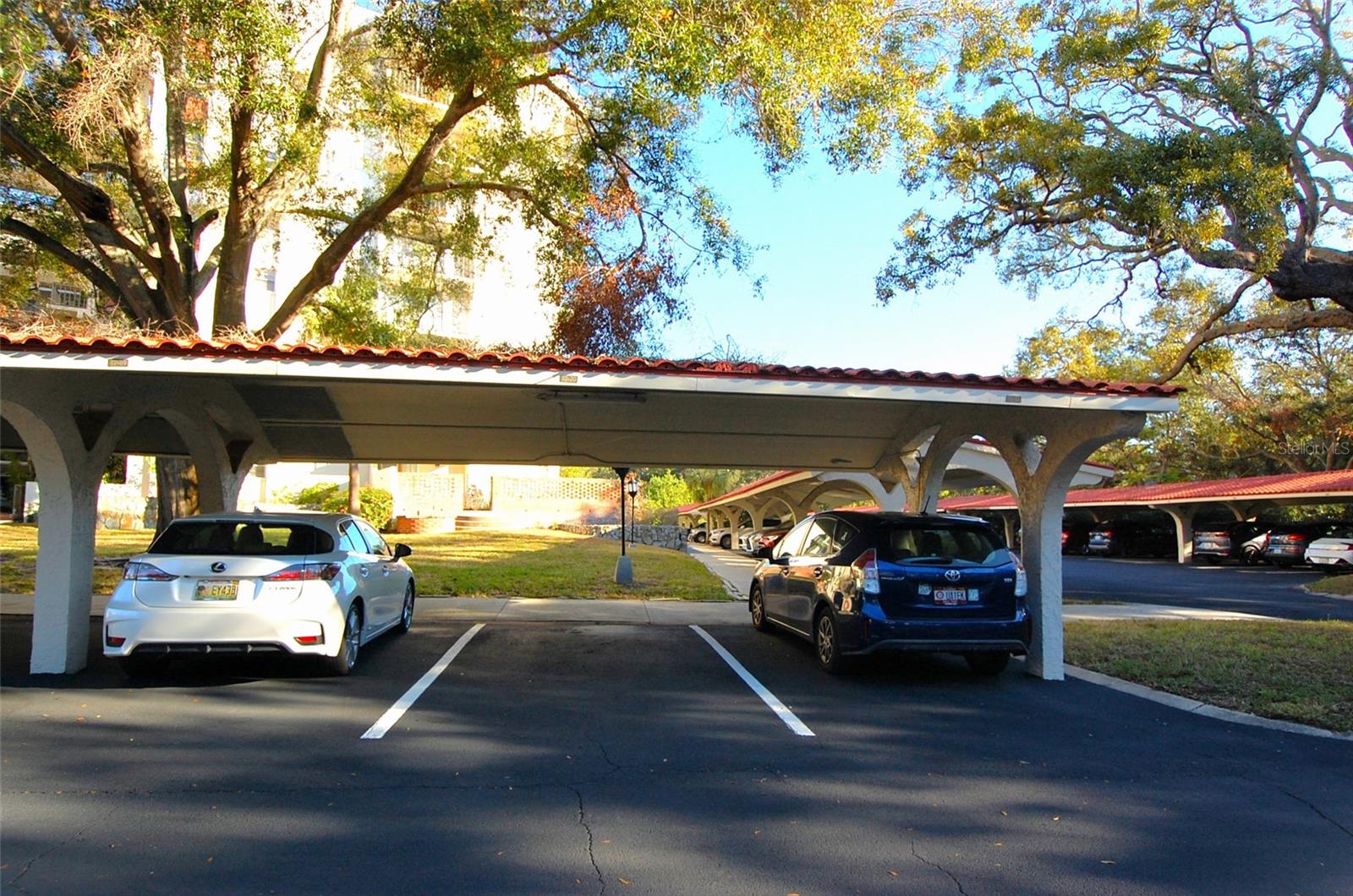 Assigned covered parking spot with uncovered spaces for guests