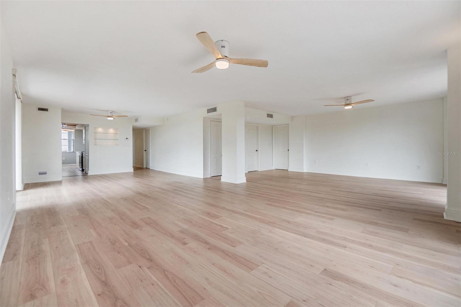 Spacious and open living room and dining room looking toward kitchen