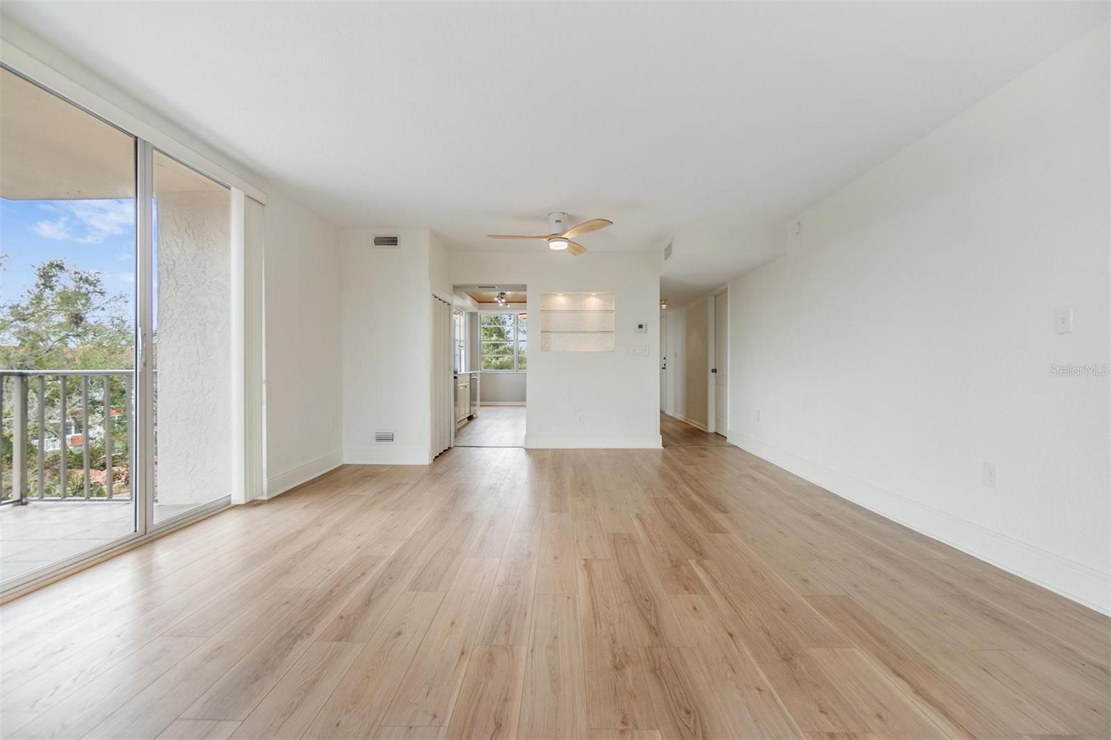 Dining area is just off kitchen and offers tree top views and access to smaller balcony through glass sliders.