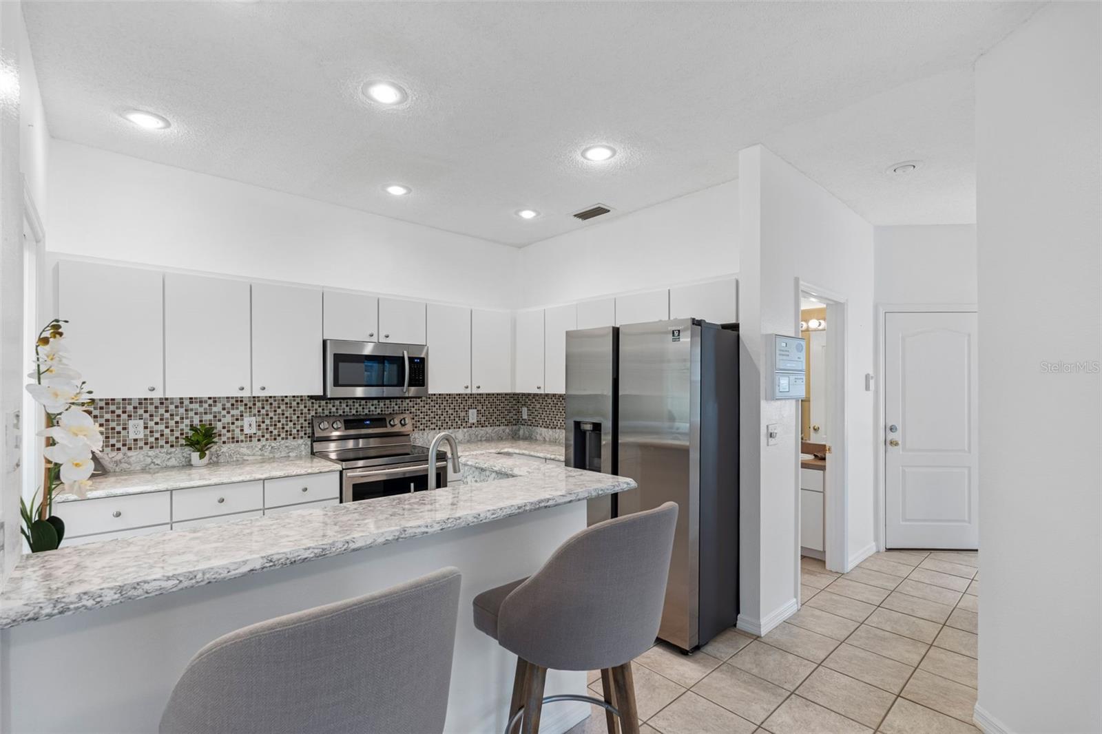 Kitchen with stainless appliances and bar top