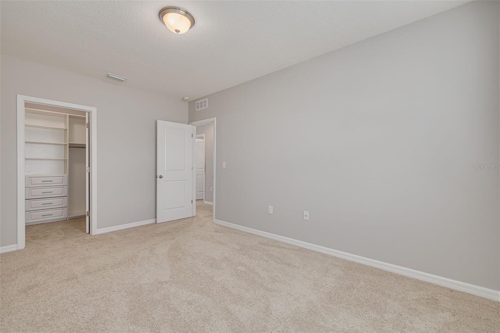 Guest Bedroom 3 with Custom Shelving in Closet