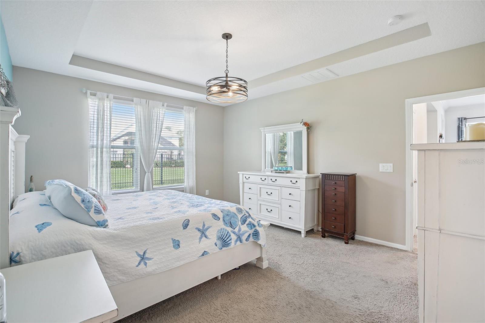 Master bedroom with view of backyard