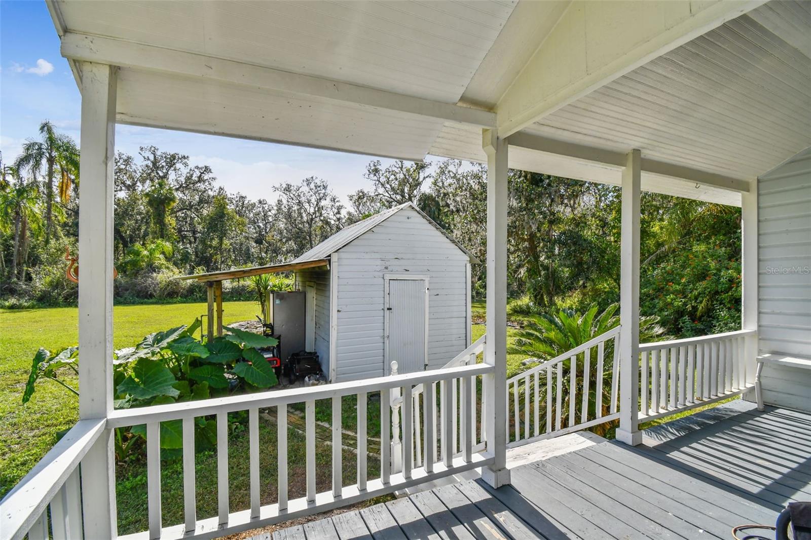 Secondary back porch overlooking the historic smokehouse