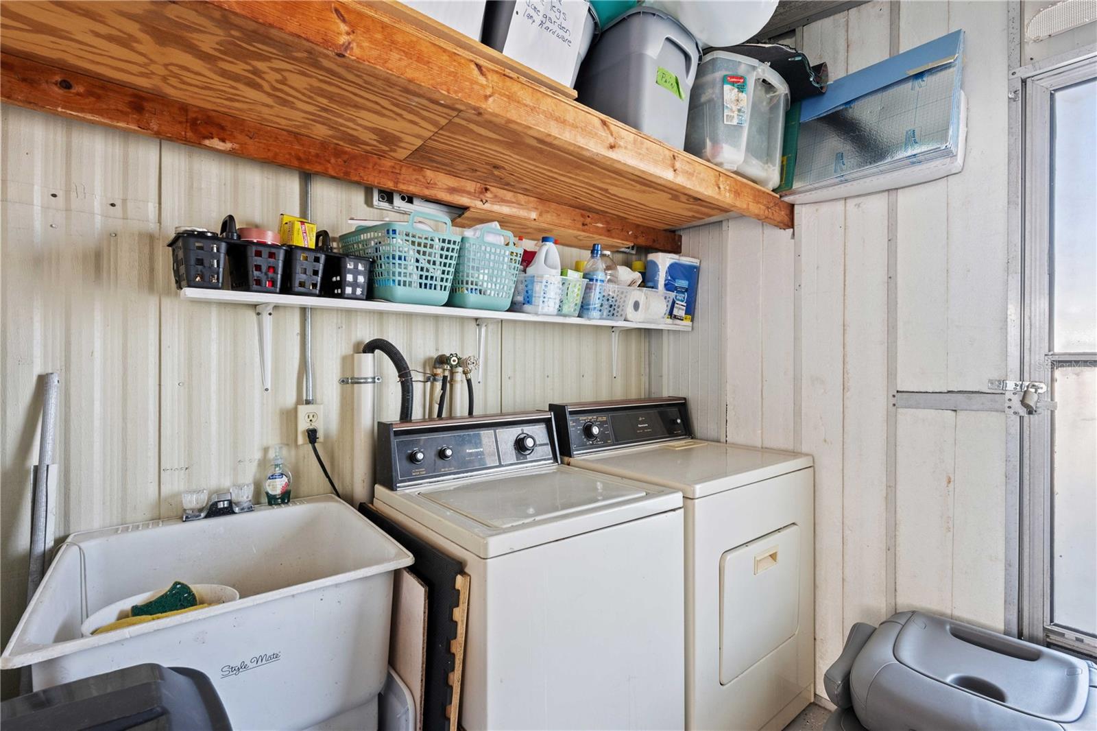 Outside laundry has storage and sink