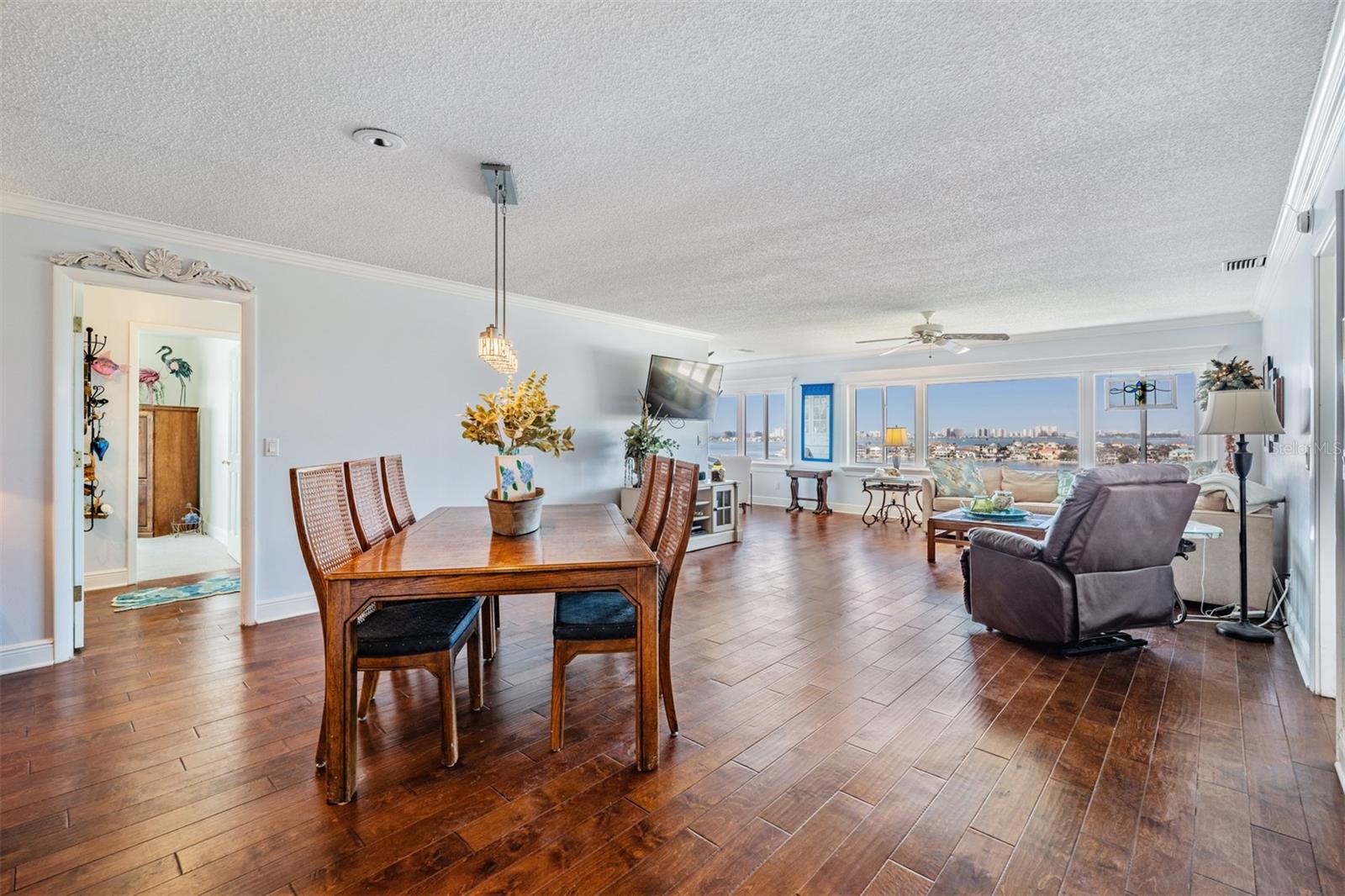 Large Dining Room area open to the Family Room, Engineered Hardwood Flooring, crown molding and cased windows.