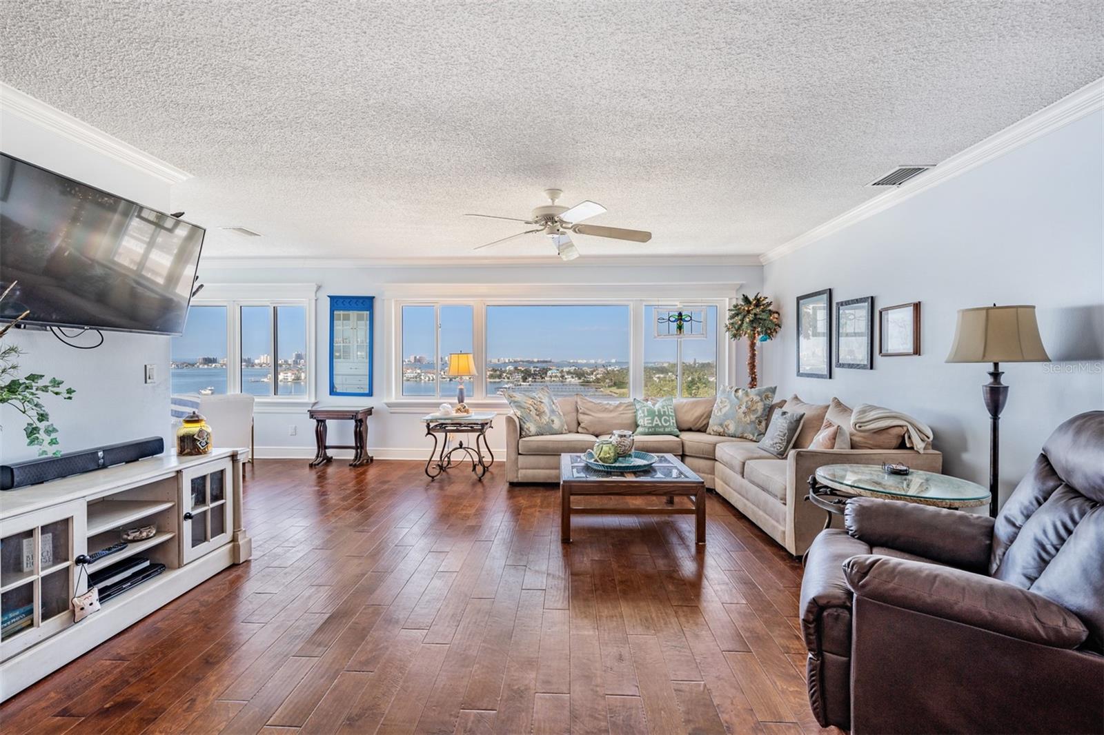 Family Room with Crown Molding, Ceiling Fan and Cased Windows - so much natural light coming in and the views are stunning!