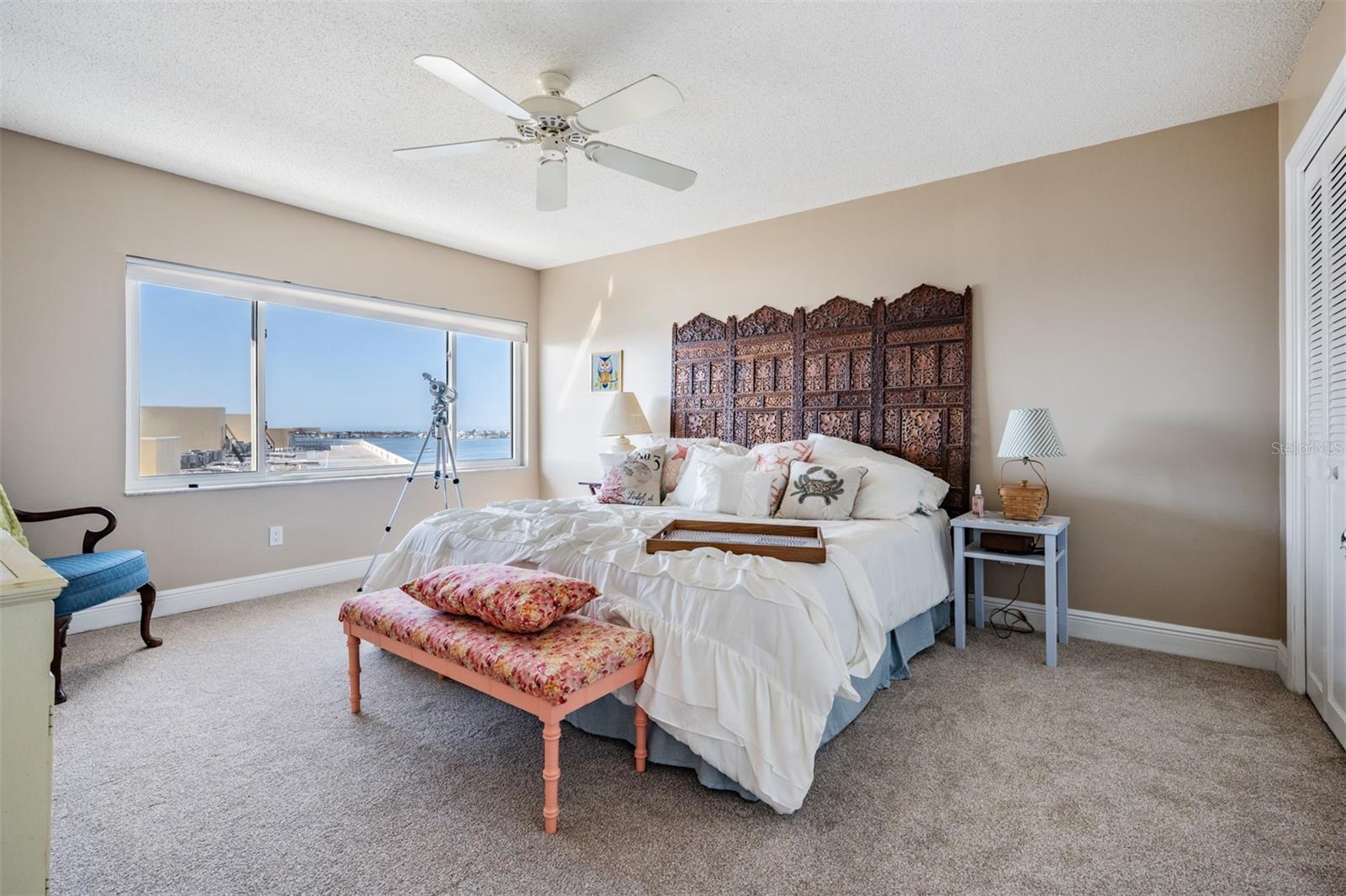 Spacious Guest Bedroom, stunning water views, new carpet and a ceiling fan.