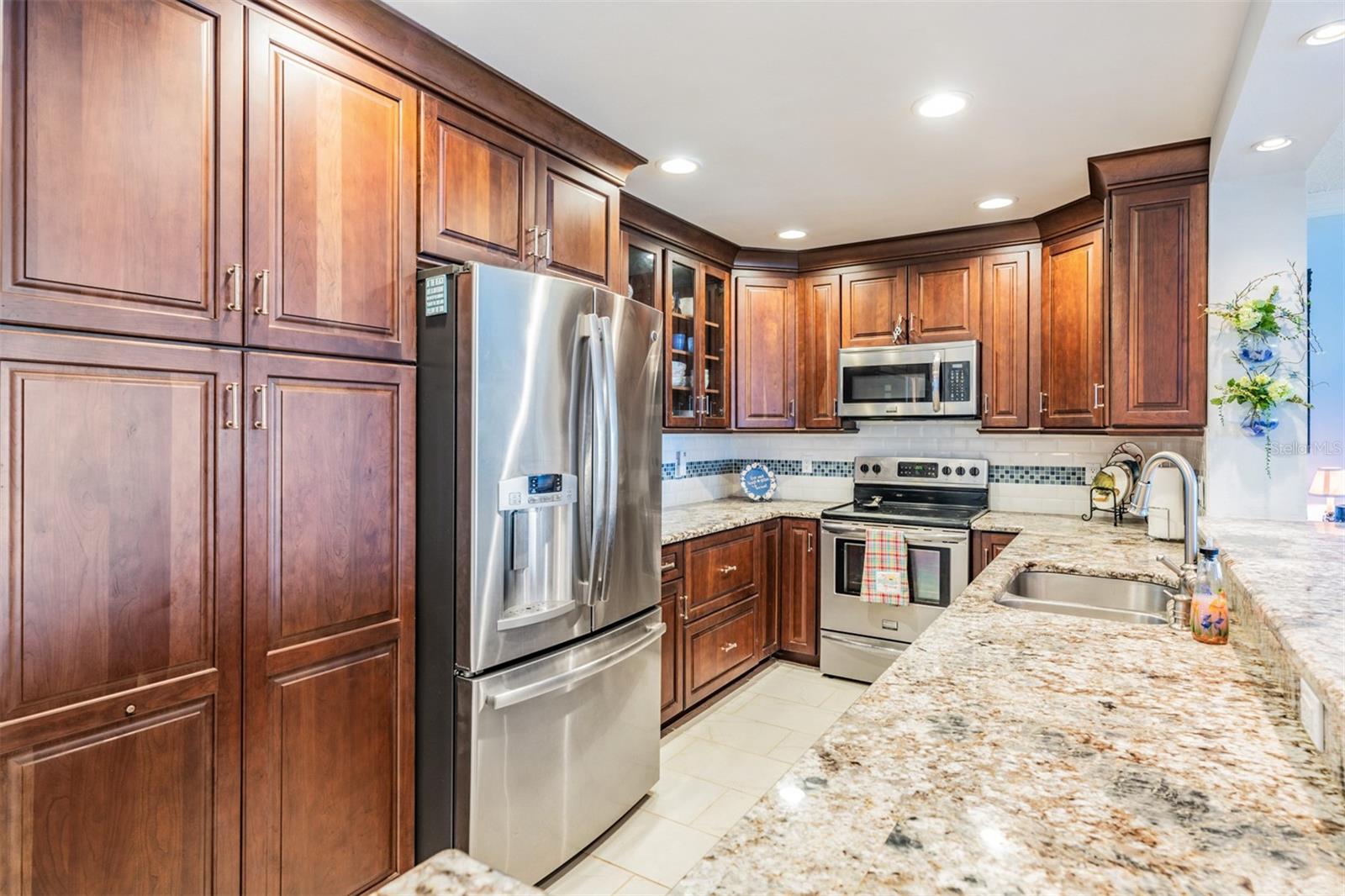 Updated and Open Kitchen to the Dining Room and Family Room.  Granite Countertops, Stainless Steel Appliances and Inset Lighting and bar area.