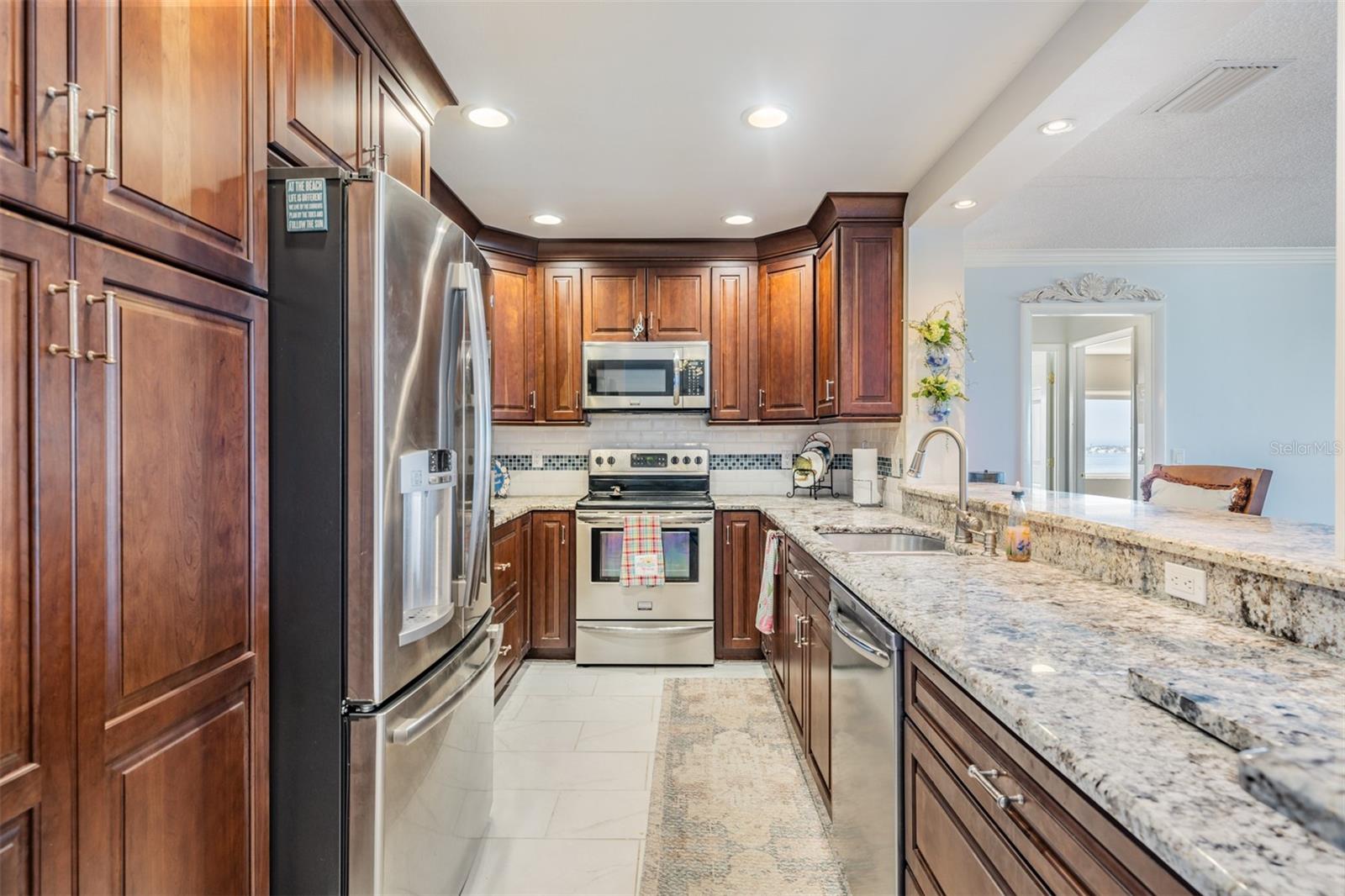 Updated and Open Kitchen to the Dining Room and Family Room.  Granite Countertops, Stainless Steel Appliances and Inset Lighting and bar area.