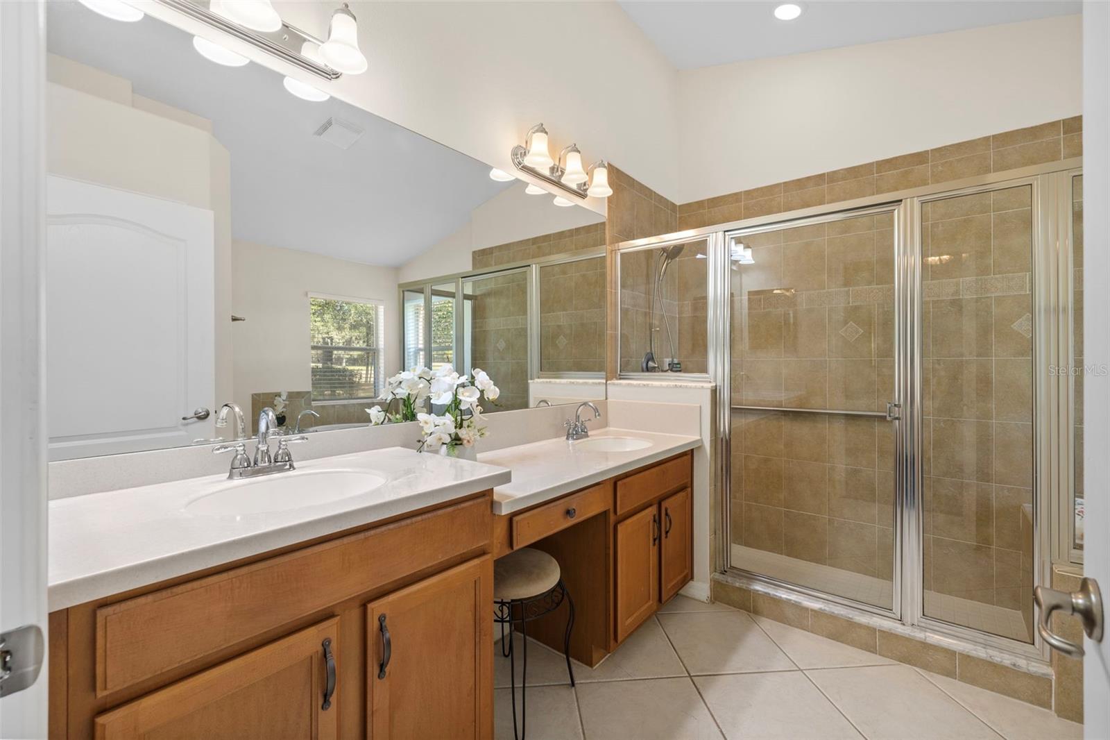 Primary bath offering a large walk-in shower with bench.