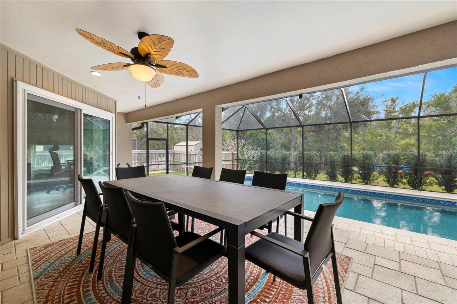 Large covered patio with two kitchen pass through bars for entertaining