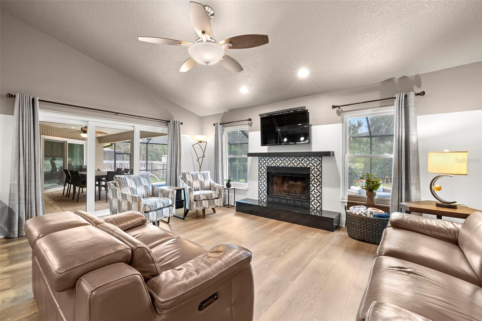 Living Room/Dining/Kitchen great room with woodburing fireplace and pocket hurricane sliding door to bring the outside in