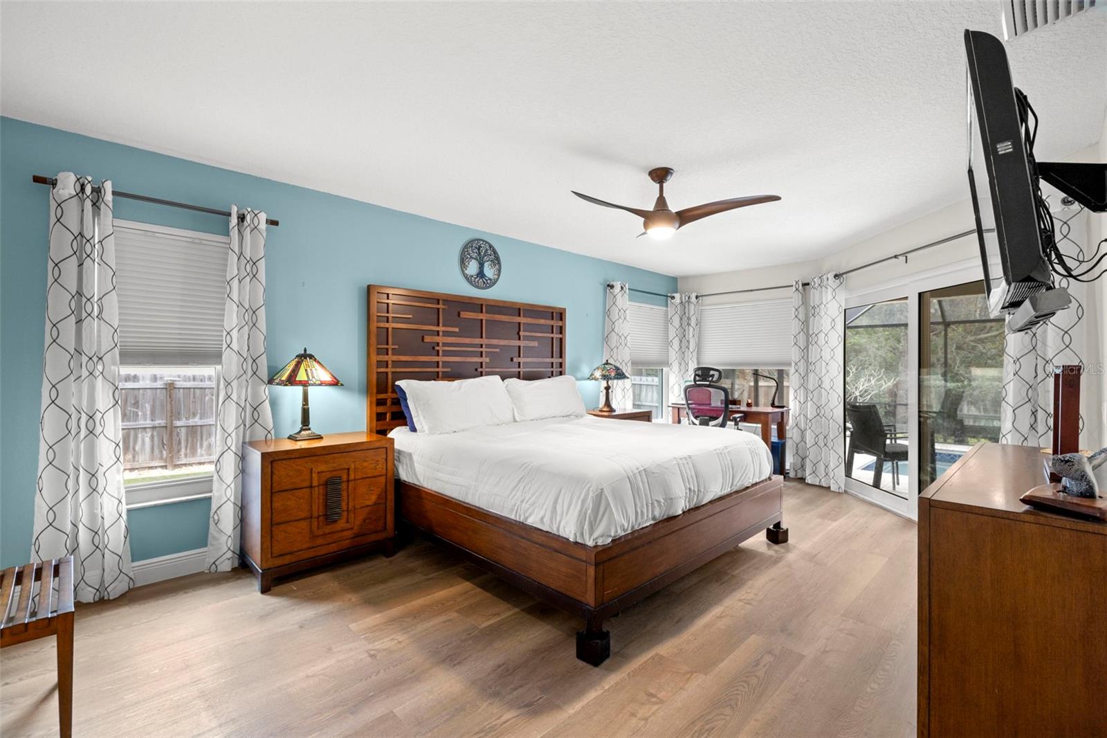 Spacious Primary bedroom overlooks the beautiful pool and private back yard