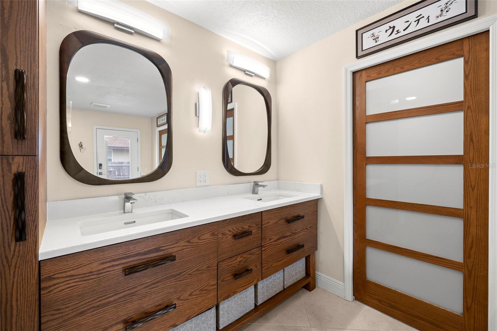 Custom updated primary bath has too many upgrades to list from quarts countertops, custom pocket doors to 6 by 6 ft walk in closets, double sinks, bidet, tub and walkin shower