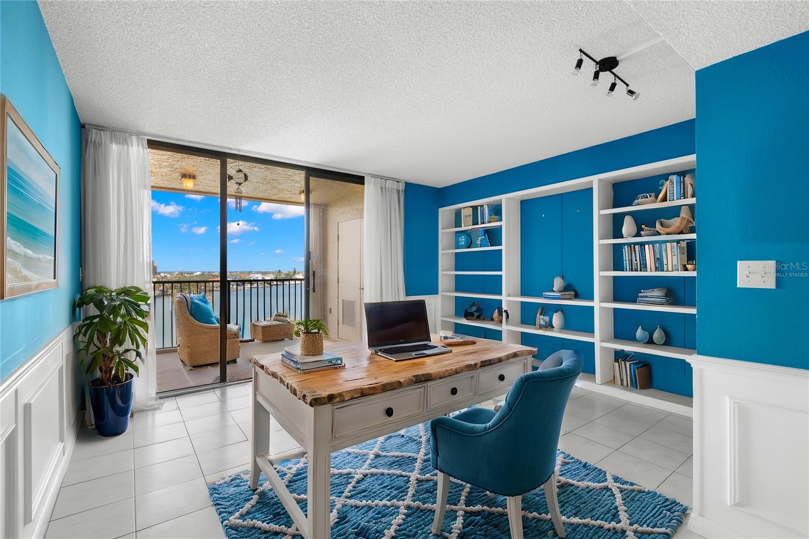 Study/Den with wall molding and built-in bookshelves also has sliders that open to the 1st balcony shared with the living room. There is also a built-in closet, so just add doors for use as a 3rd bedroom! Virtually Staged