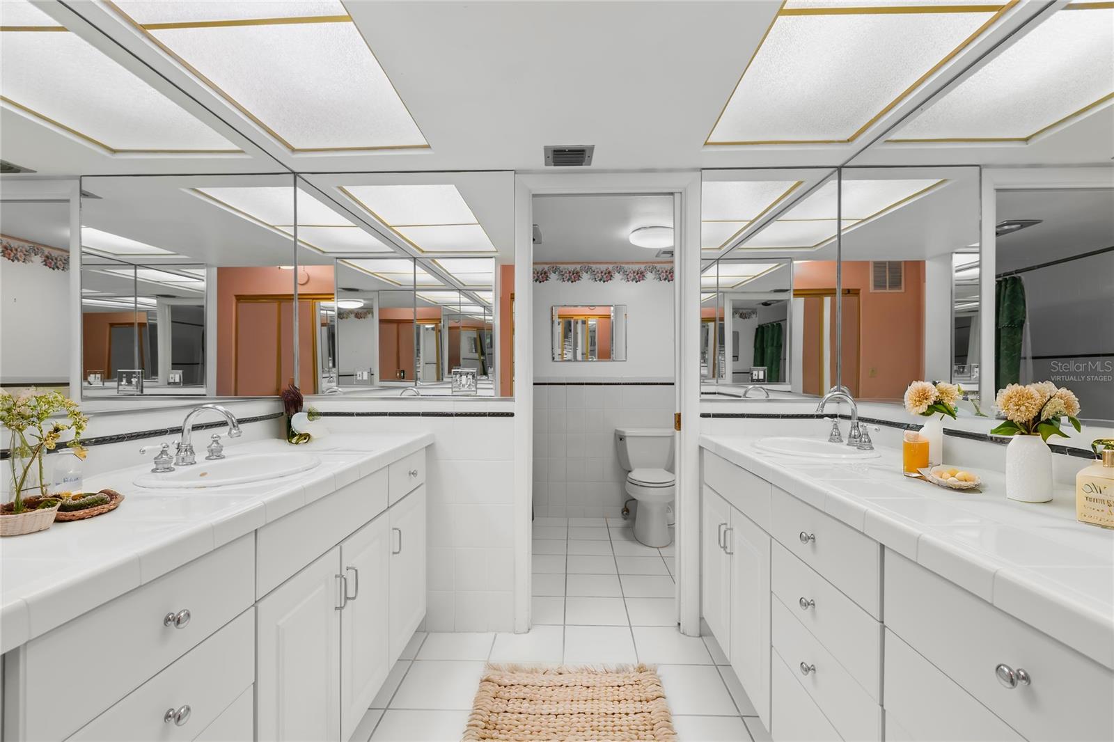 Dual vanities and sinks in the Primary En Suite Bath - virtually staged