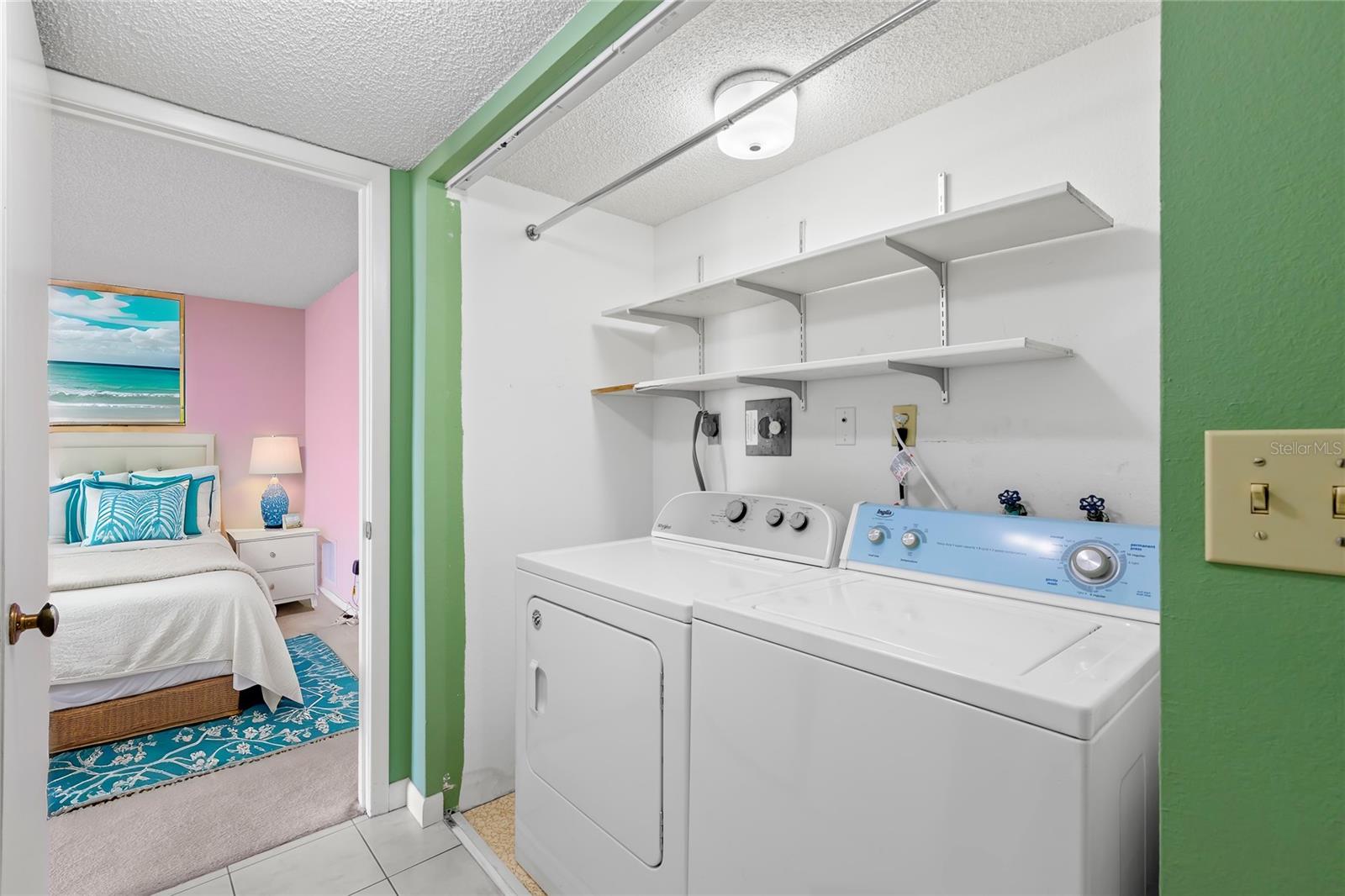 Full size Washer/Dryer are included. There are closet doors included as well that were not attached at the time of this photo. Virtual staging (in bedroom behind).