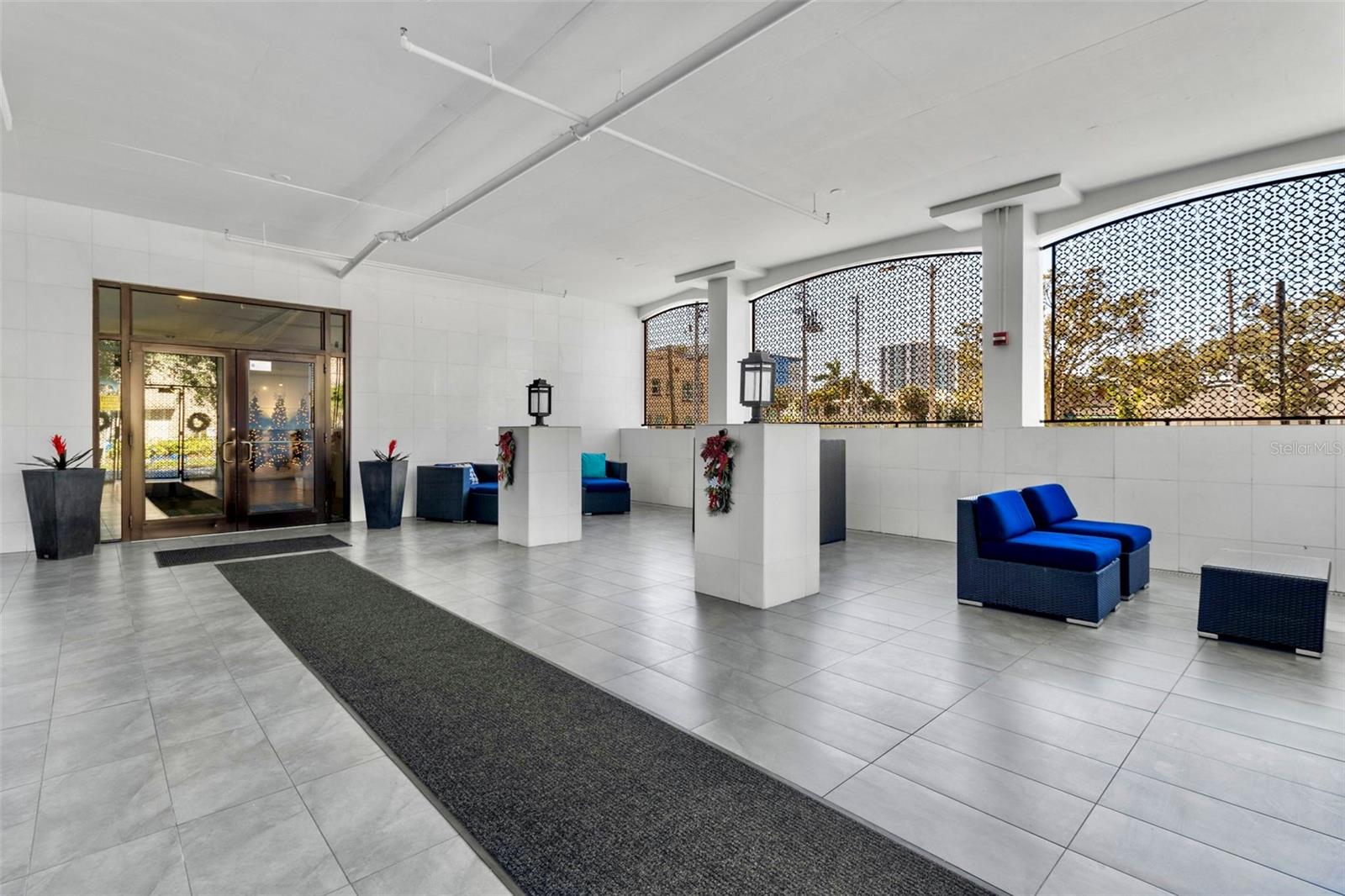 Gated and secure open-air lobby with seating leads to an interior lobby.