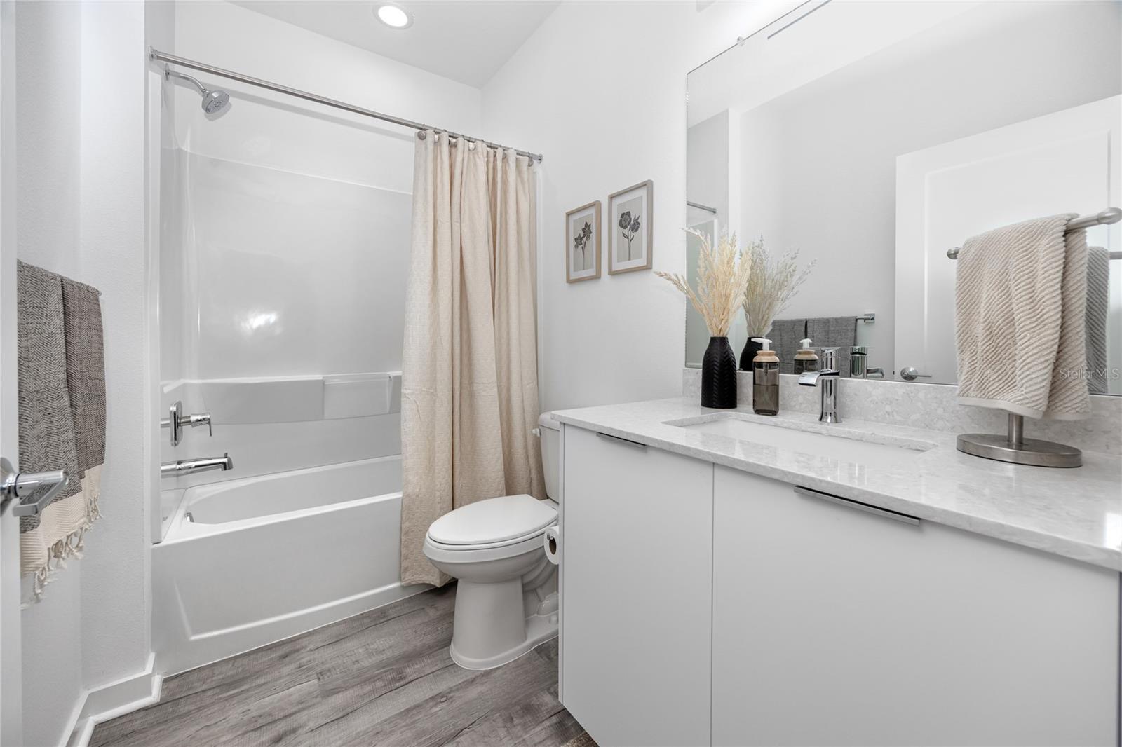 Downstairs guest bathroom with shower/tub combo