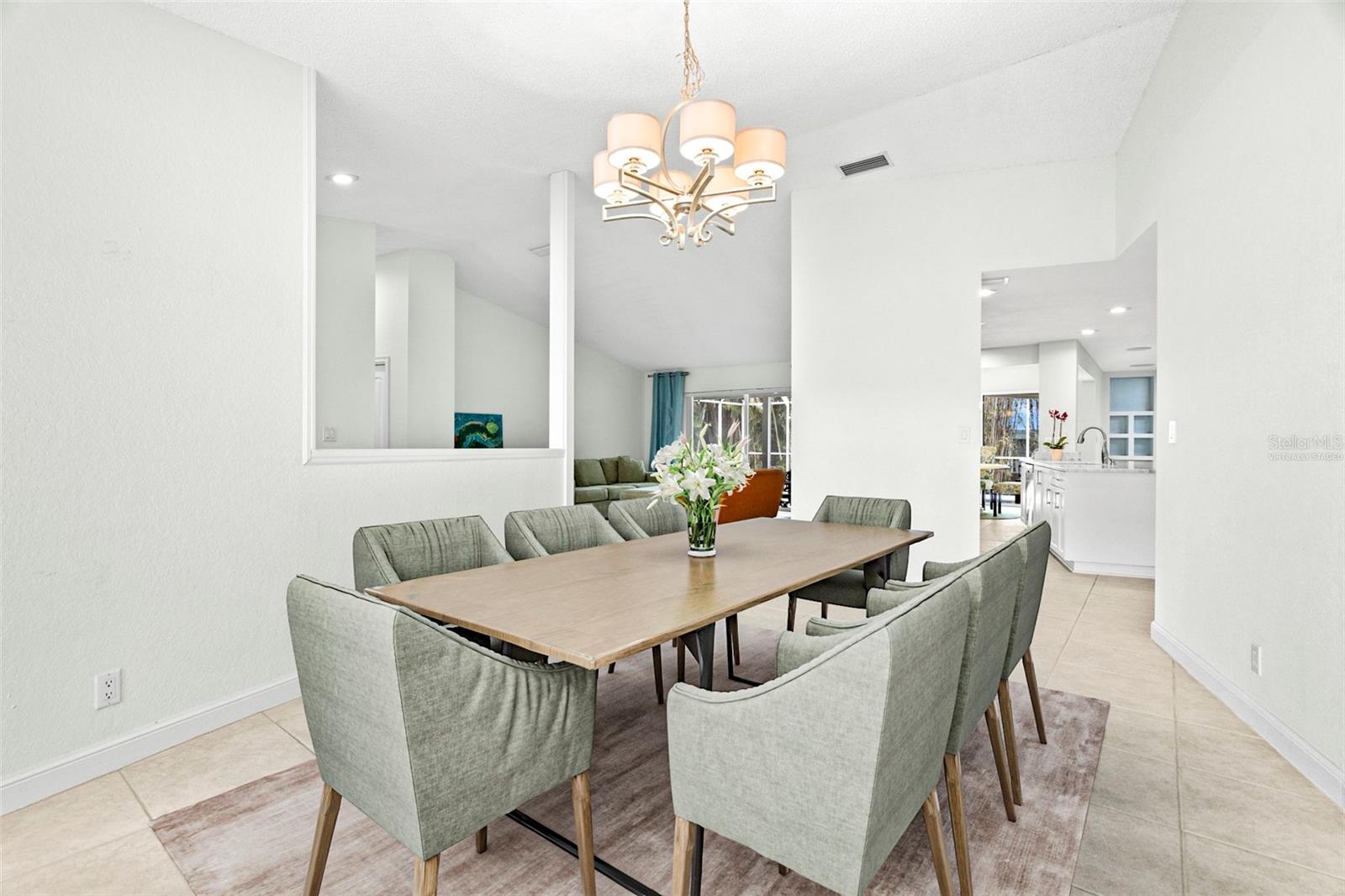 Virtually staged. The living and dining areas connect seamlessly to a beautifully appointed kitchen.