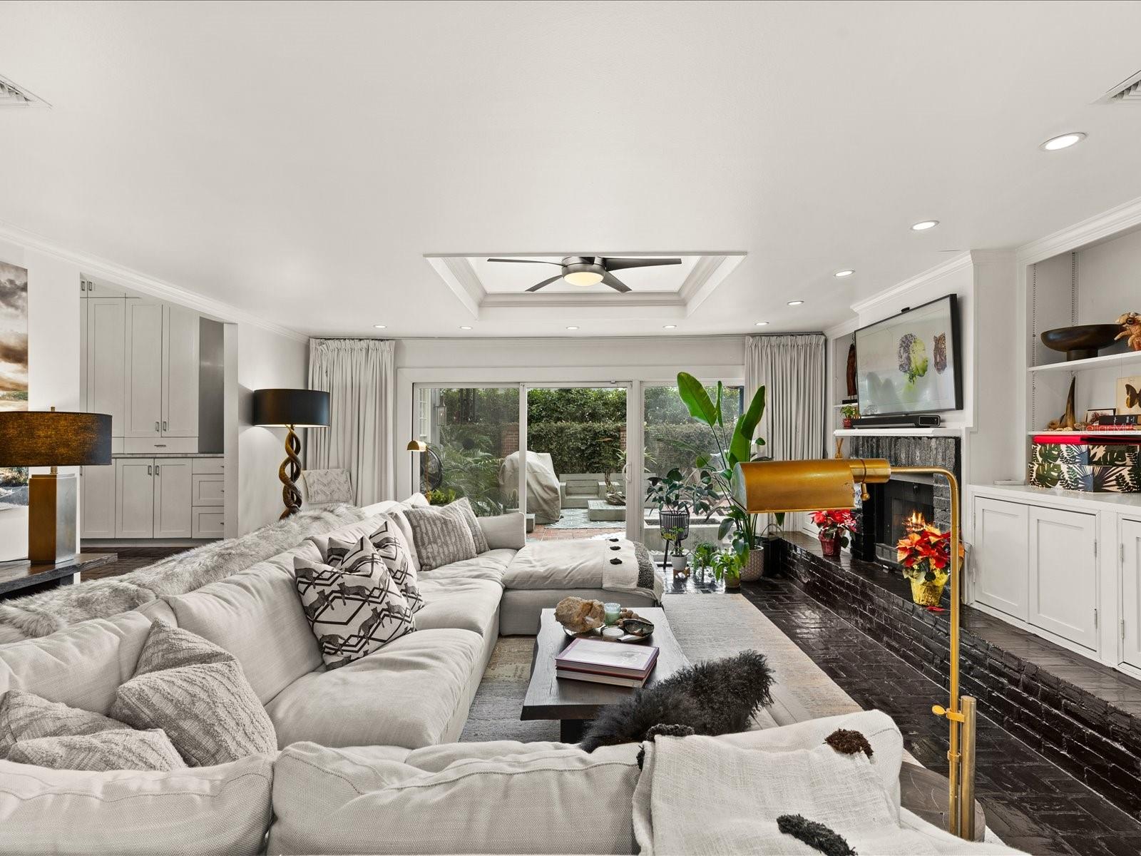 Sunken Family Room with Fireplace and entrance to outdoor living space