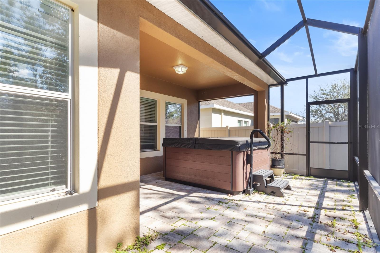 Screened patio with a hot tub