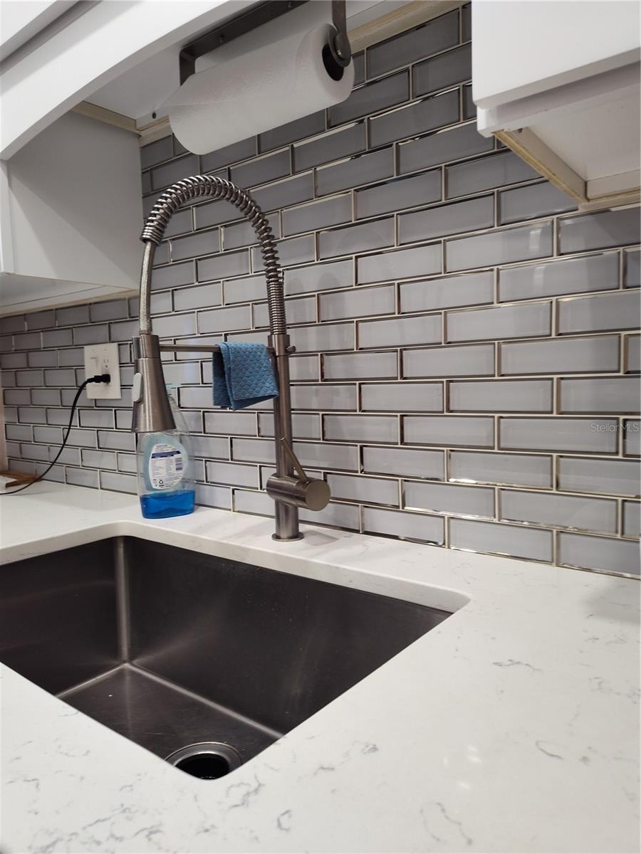 Faucet, sink and backsplash tiles were all replaced at the time of remodeling