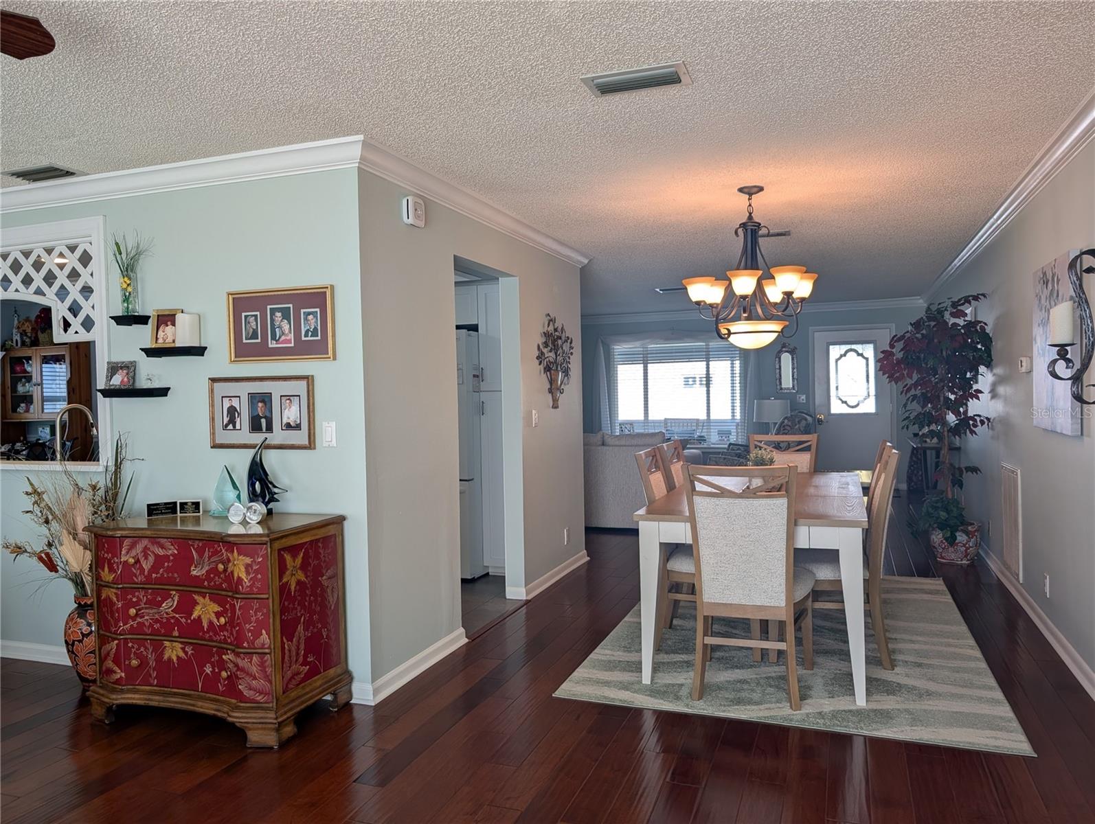 View of kitchen from Florida room into open dining/living rooms.