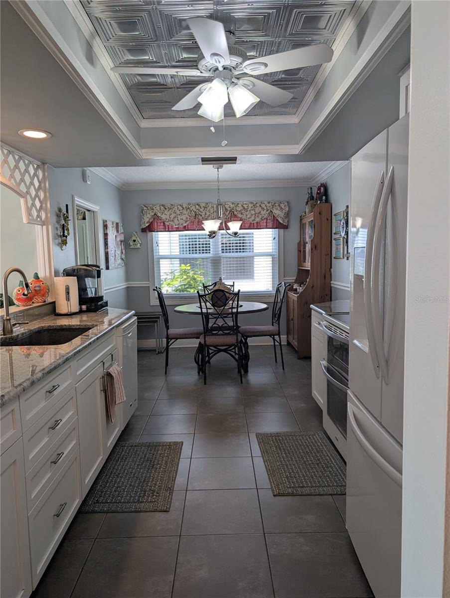 Full shot of kitchen and up-close view of inset ceiling.