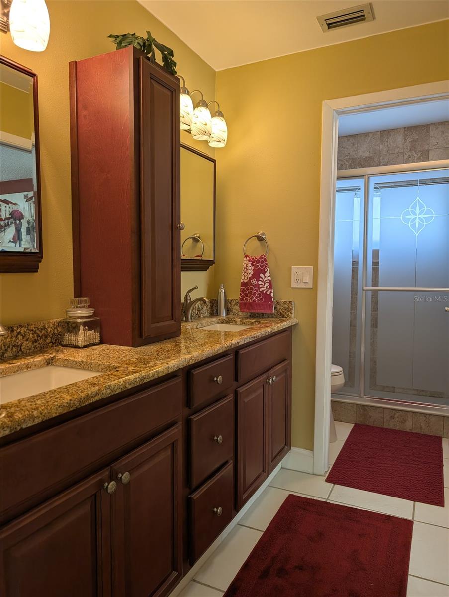 Private wet room offers stunning walk-in tiled shower and comfort height commode.