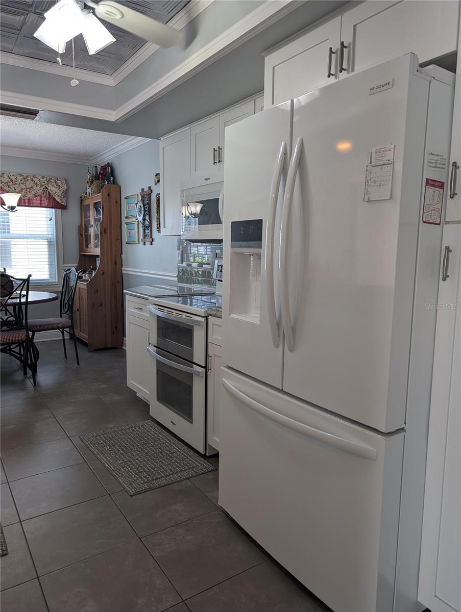 Eat in kitchen with window for natural light.  Faux tin tile inset ceiling with ceiling fan.