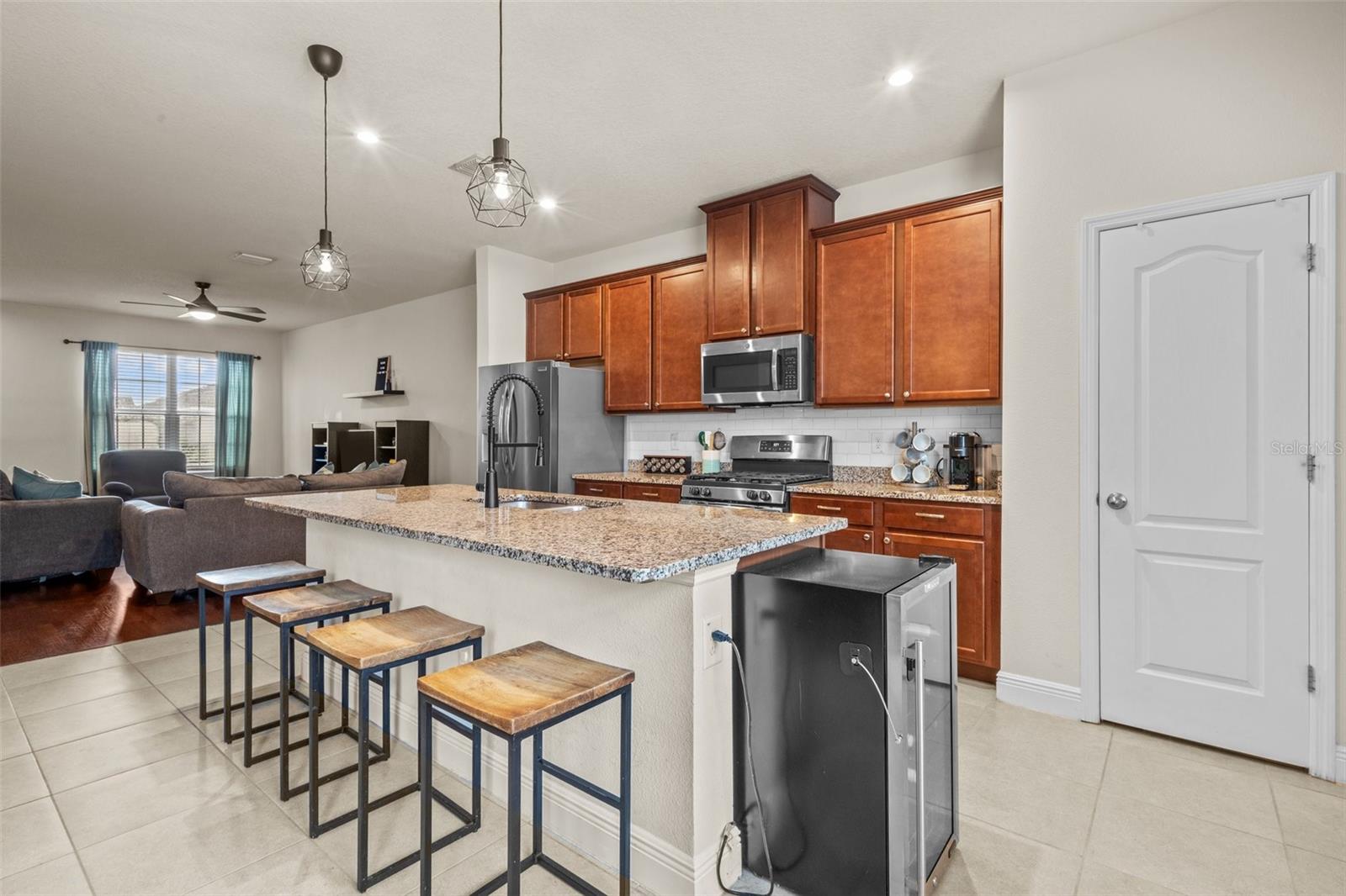 Kitchen with granite counters, stainless steel appliances, gas range, and ample room to sit at island for a quick meal or to entertain