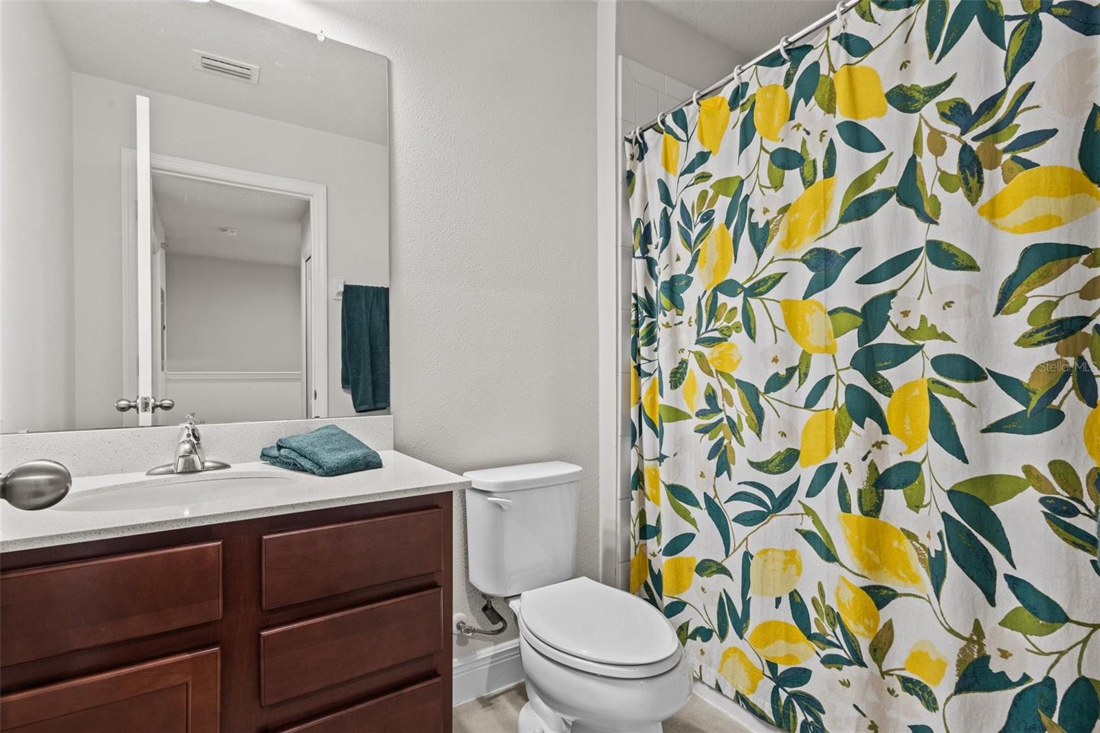 Bathroom 2 just off of bedroom 2 and bedroom 3, with quart counter and a tub/shower combo