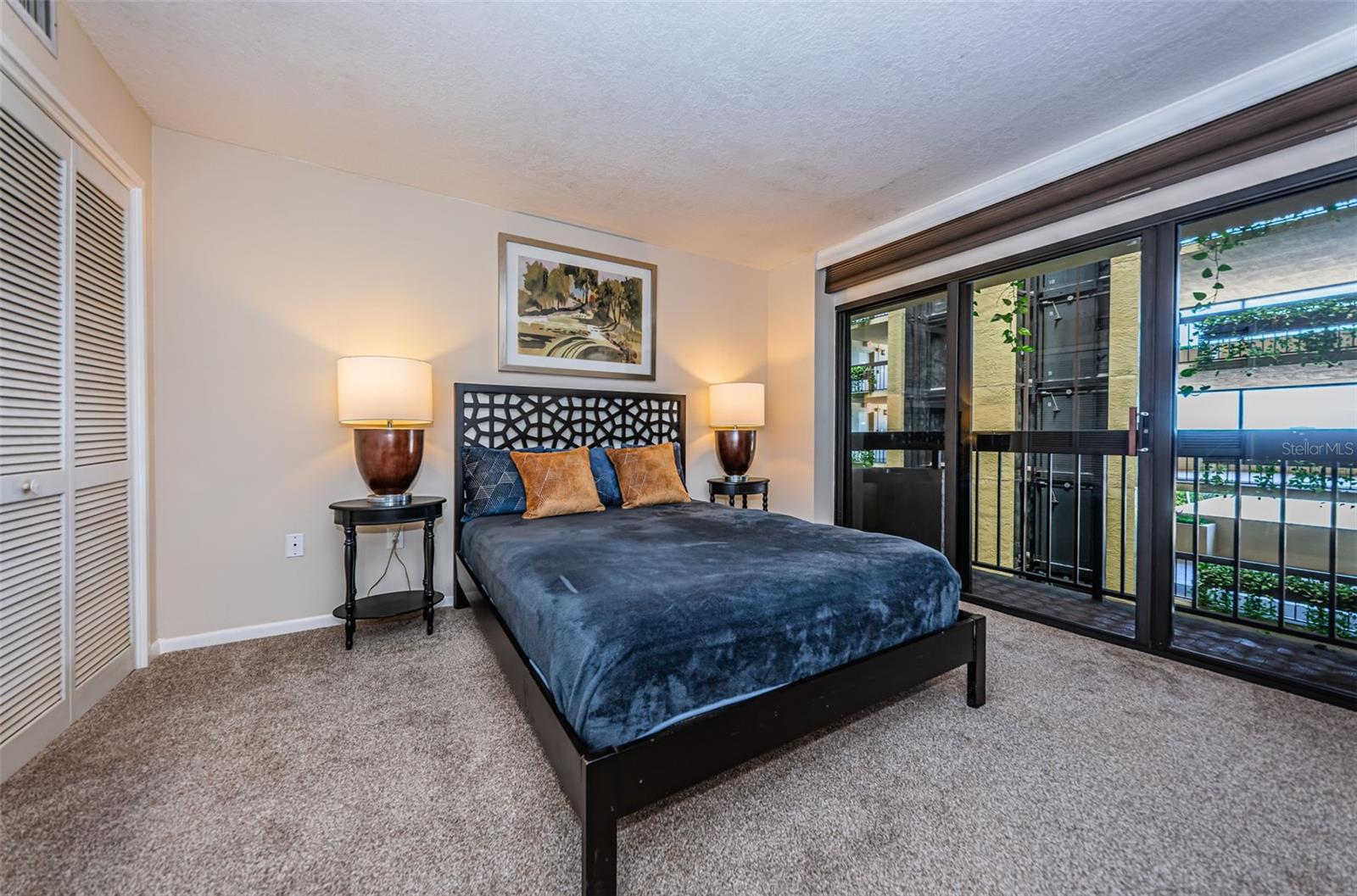 Guest bedroom with slider that overlooks the interior atrium.