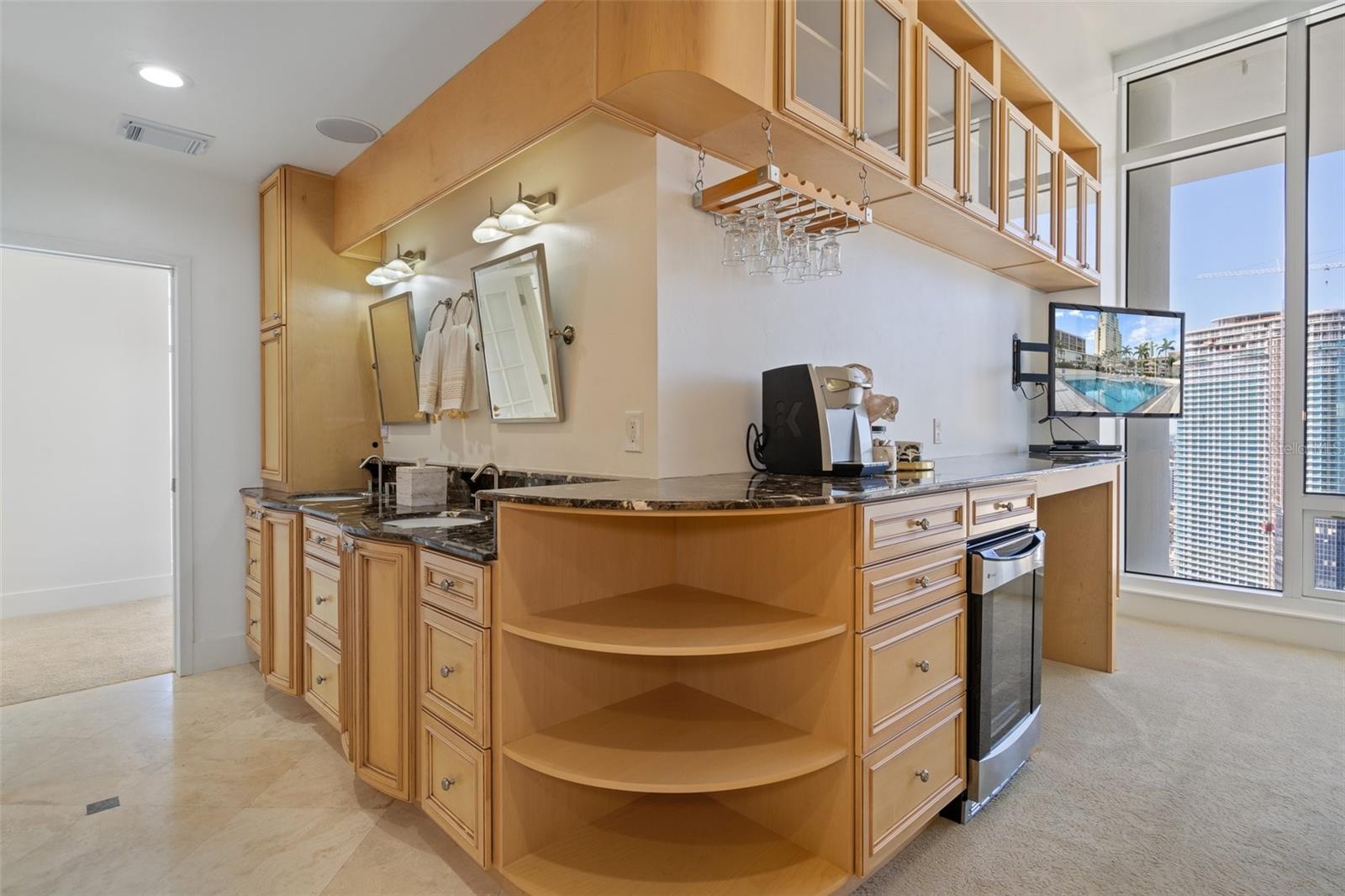 The L-shaped walk-in closet with built-ins off of the primary bathroom.