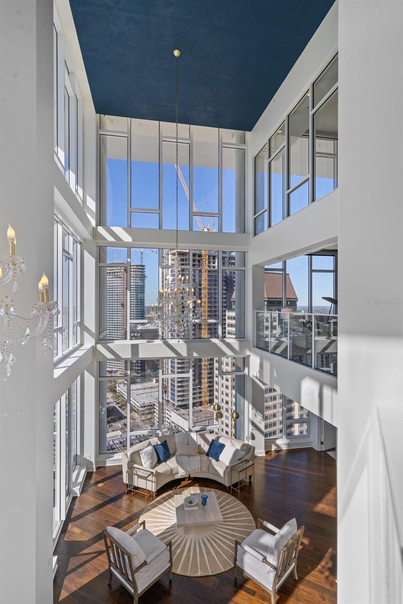 An interesting architectural feature of this three-story penthouse is the open view from each level, which allows one to peer into the living room.