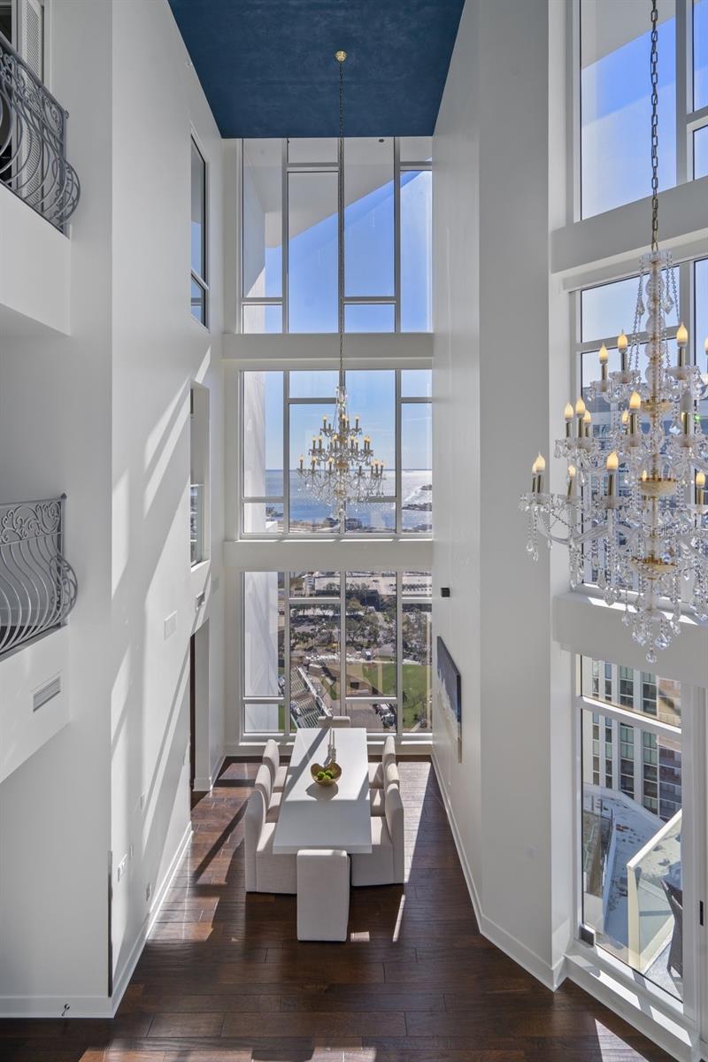 Three levels of floor-to-ceiling windows equipped with electric shades.