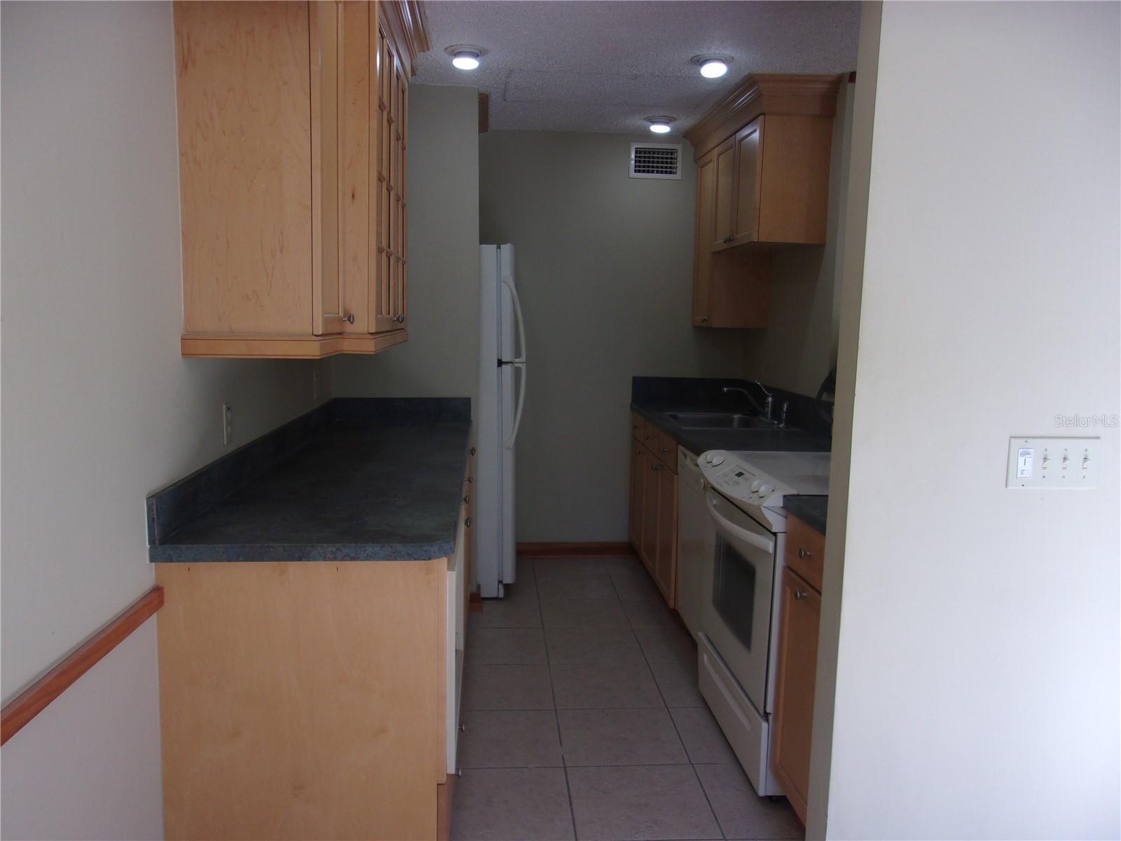 Kitchen with range, refrigerator with icemaker, dishwasher and disposal