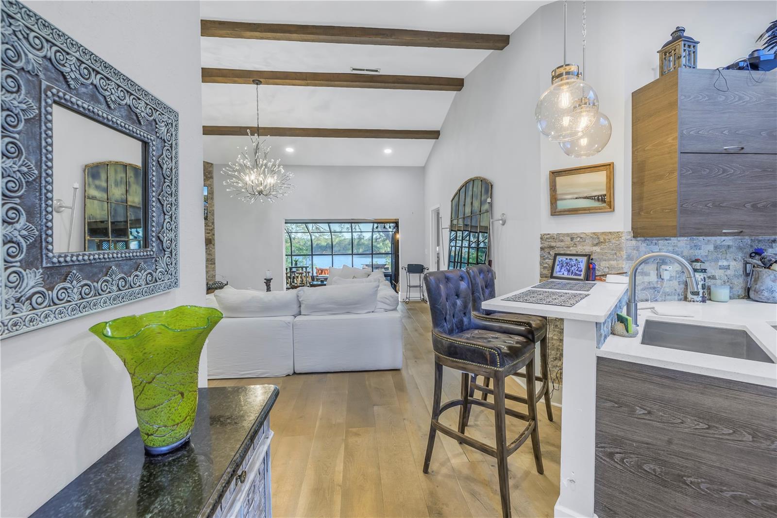 Gorgeous Entry Featuring real wood Ceiling Beams and direct view of the waterfront vista