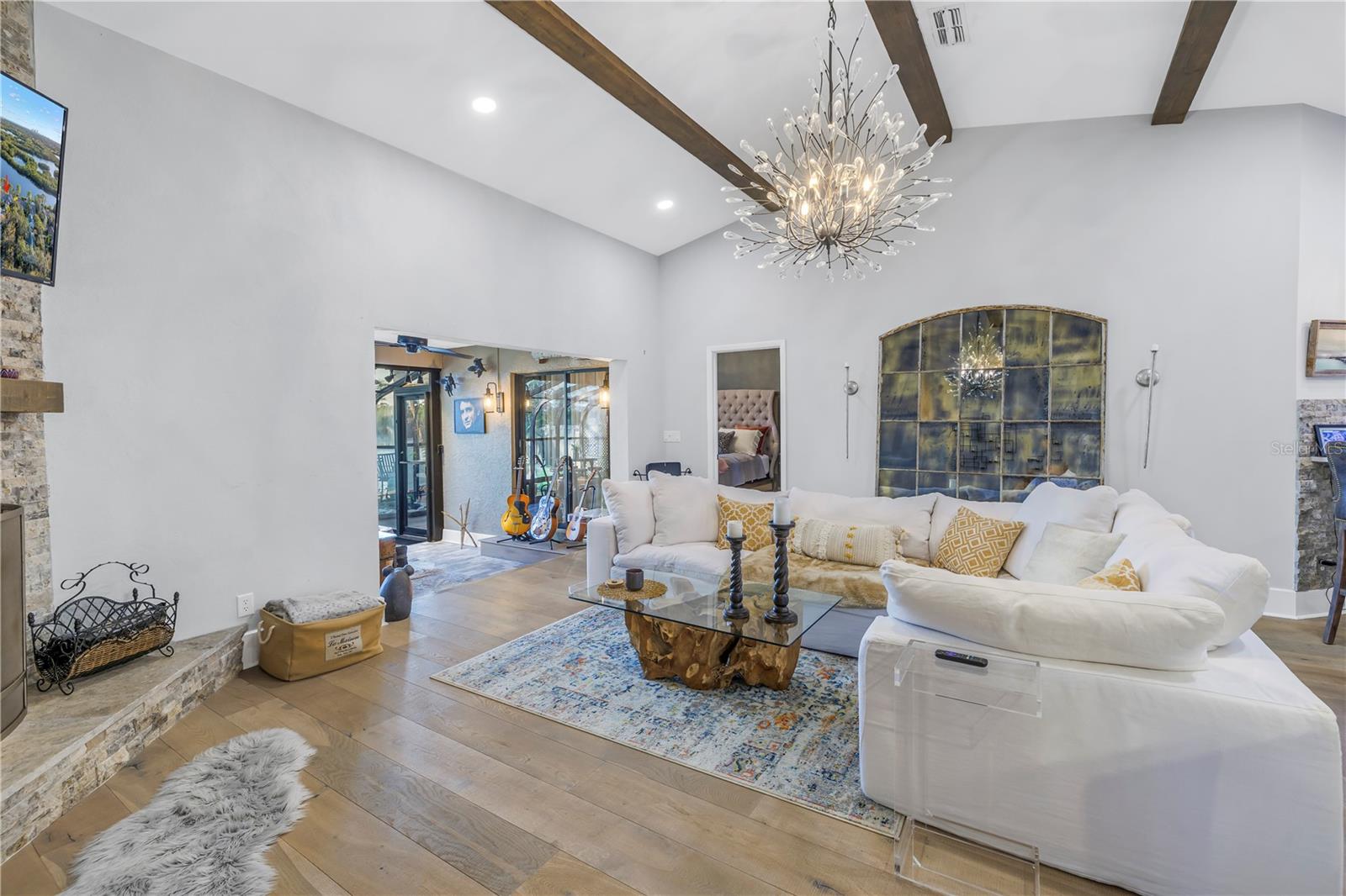 Soaring vaulted ceilings with wood beams in a really large Great Room with integrated Dining