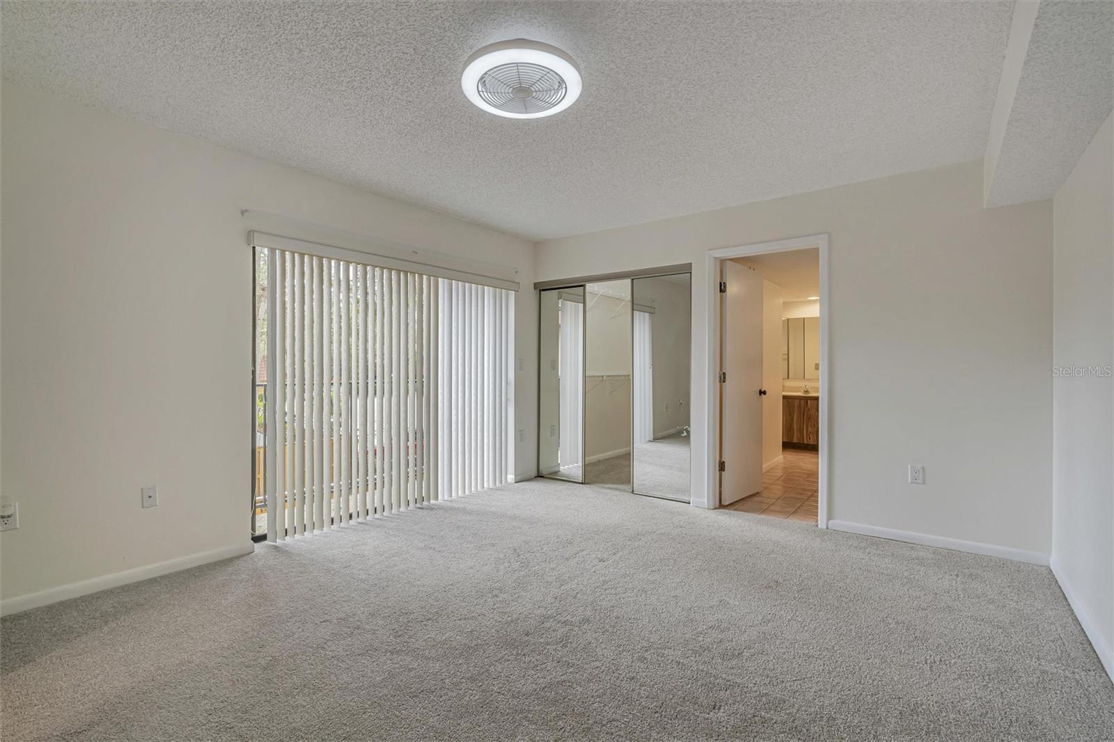 Dining area and open kitchen with new cabinets, island, sink, countertops and stainless steel appliances